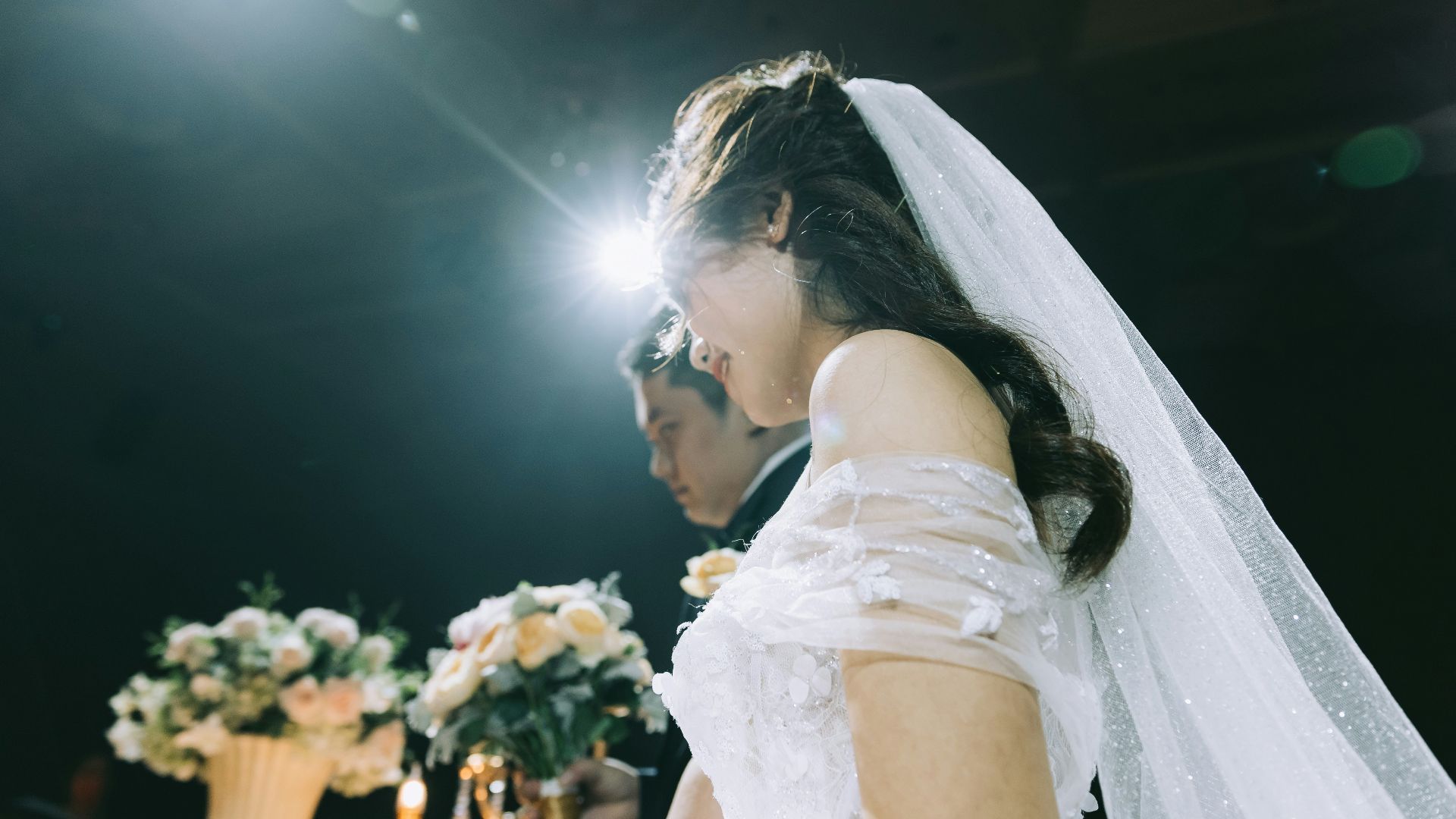 wedding couple near flower arrangements