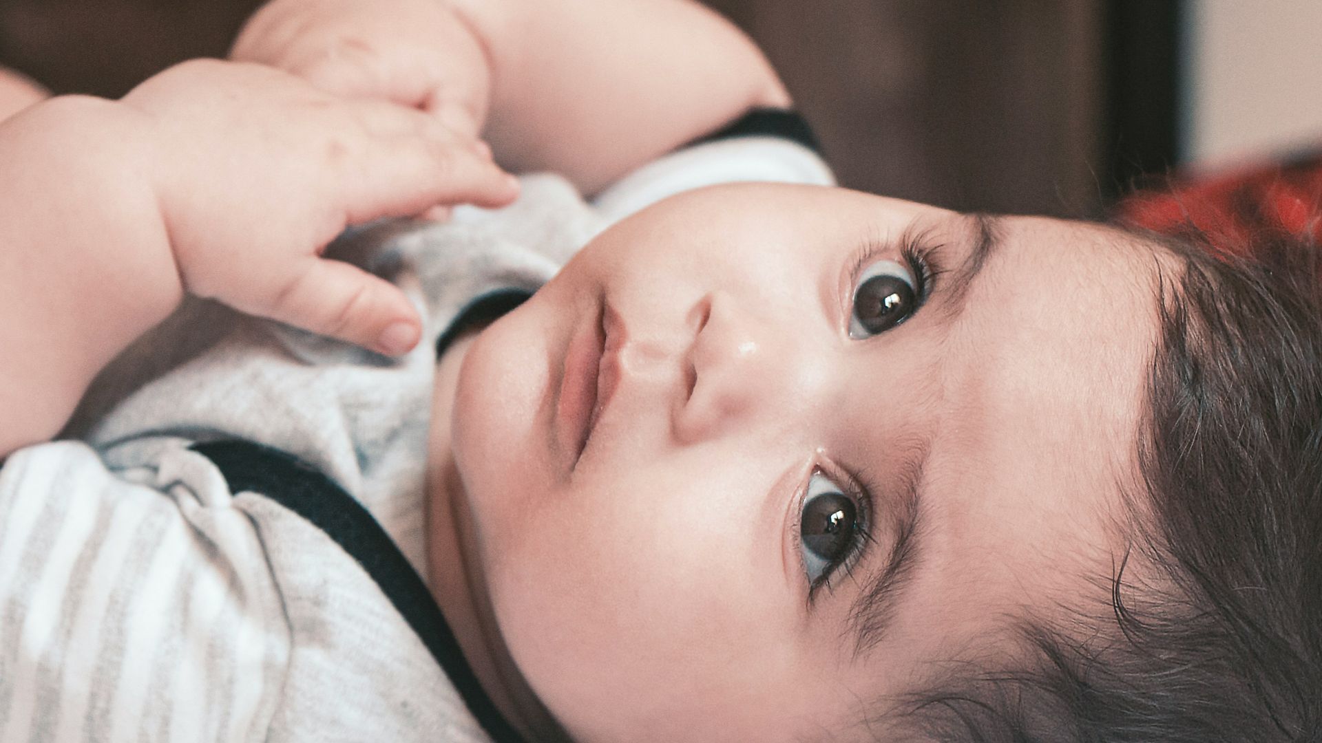 baby in white and pink shirt