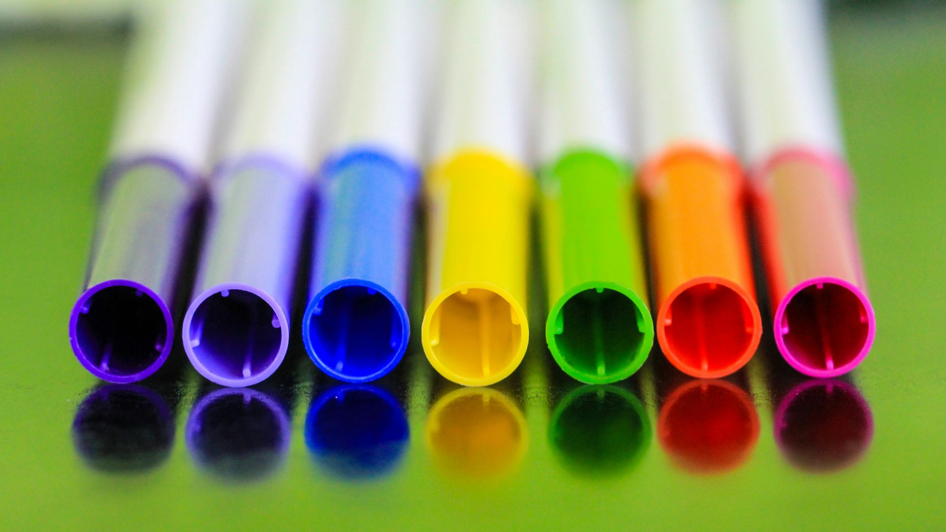 a group of colored pencils