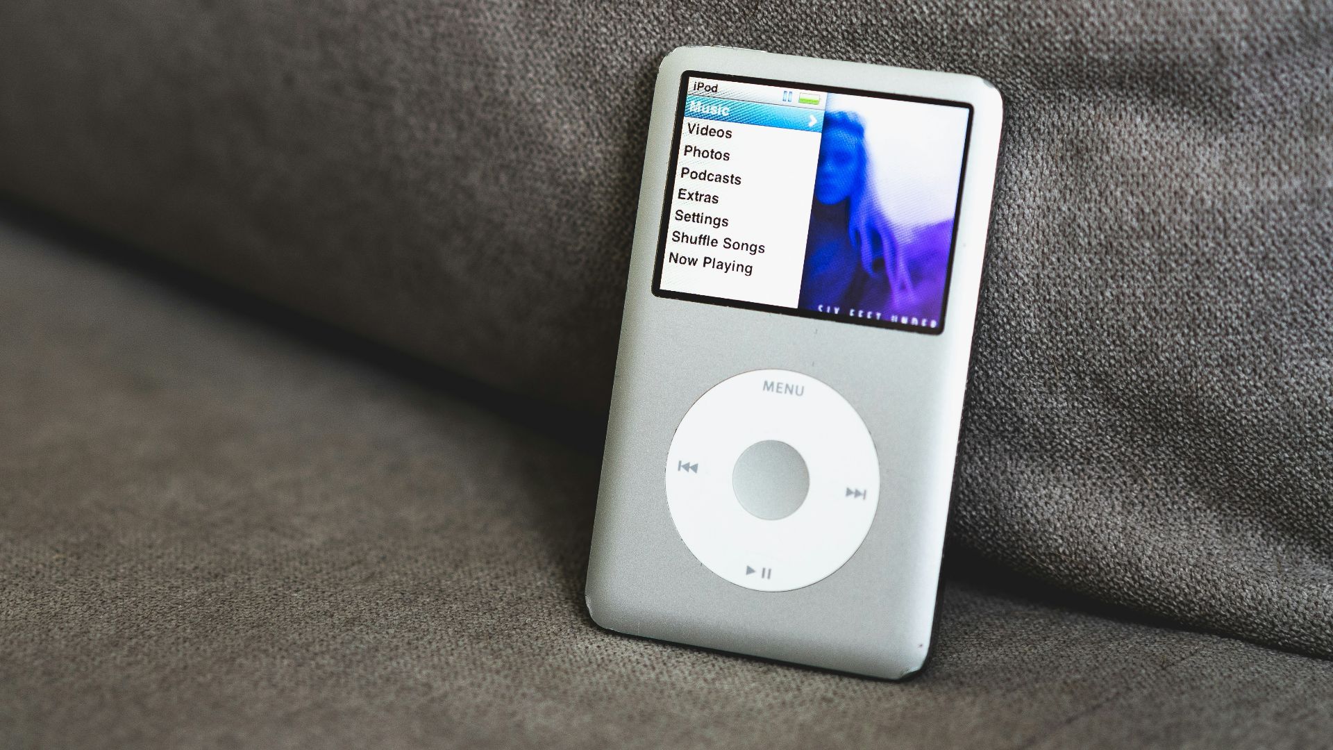 an ipod sitting on top of a couch