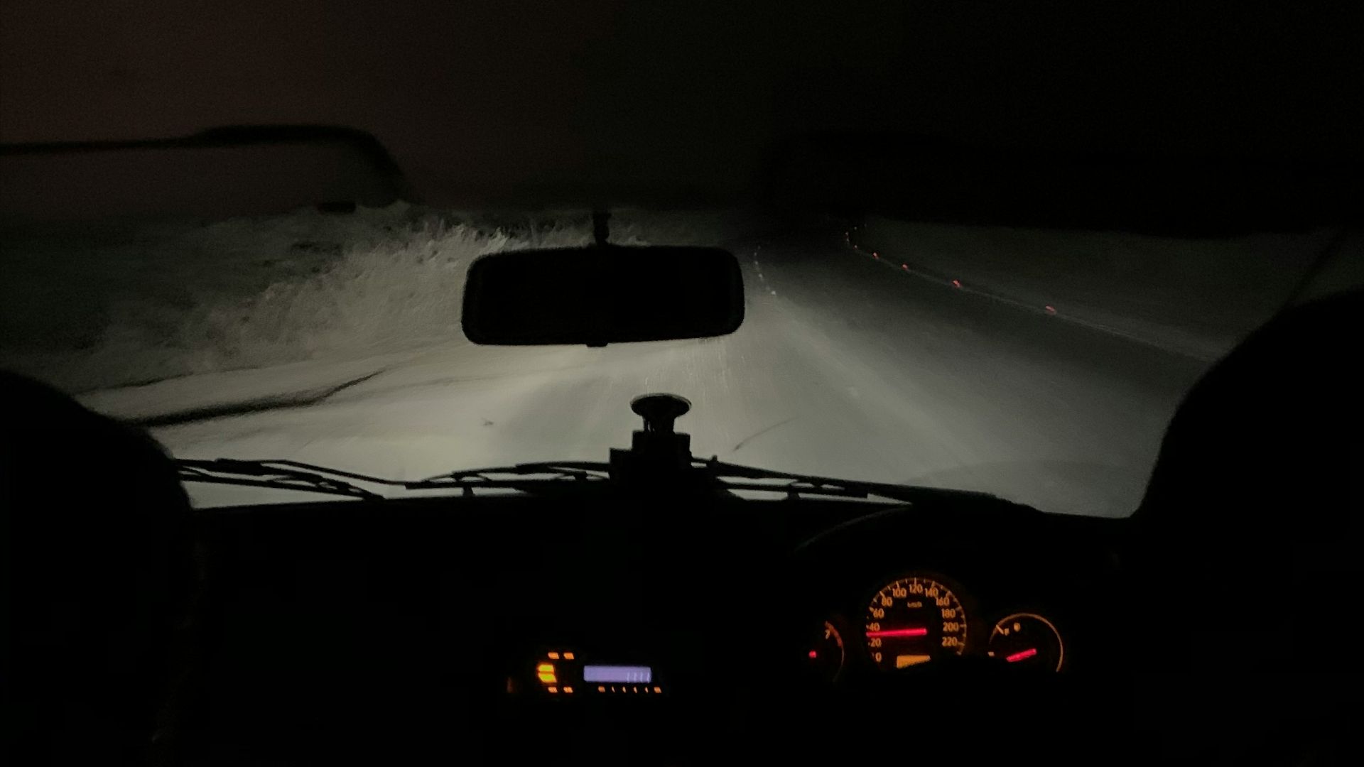 a view of the dashboard of a car in the dark
