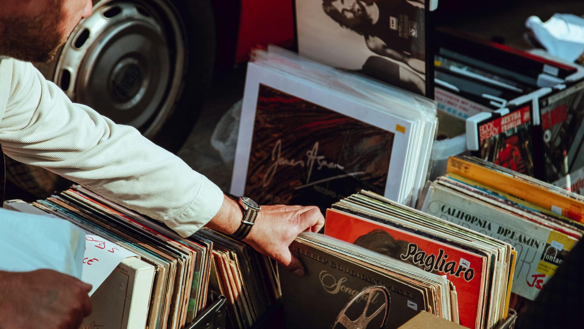 person holding vinyl records