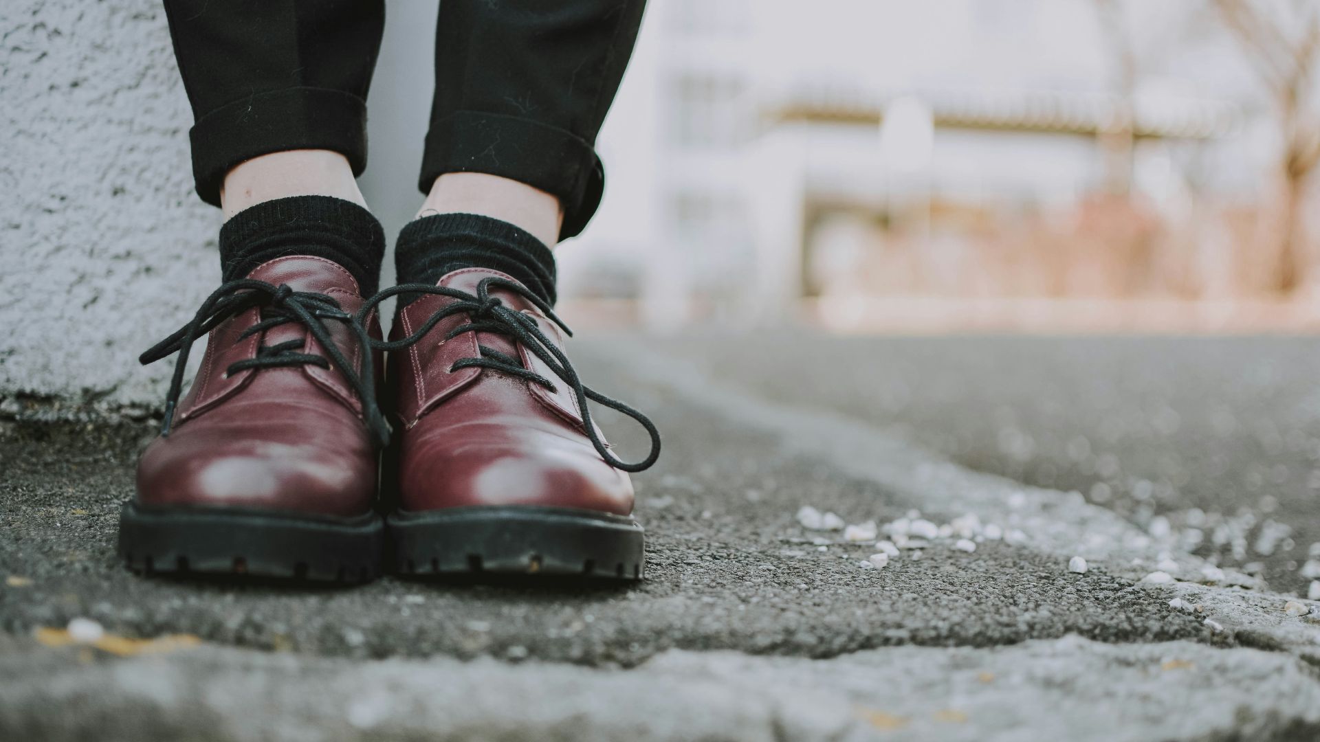 person wearing pair of brown leather shoes