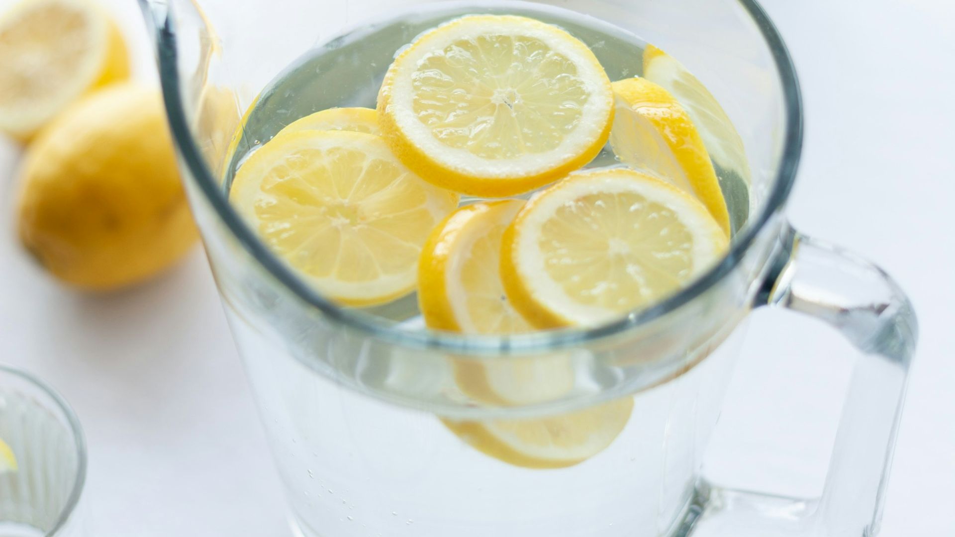slices of lemons in clear pitcher filled with water