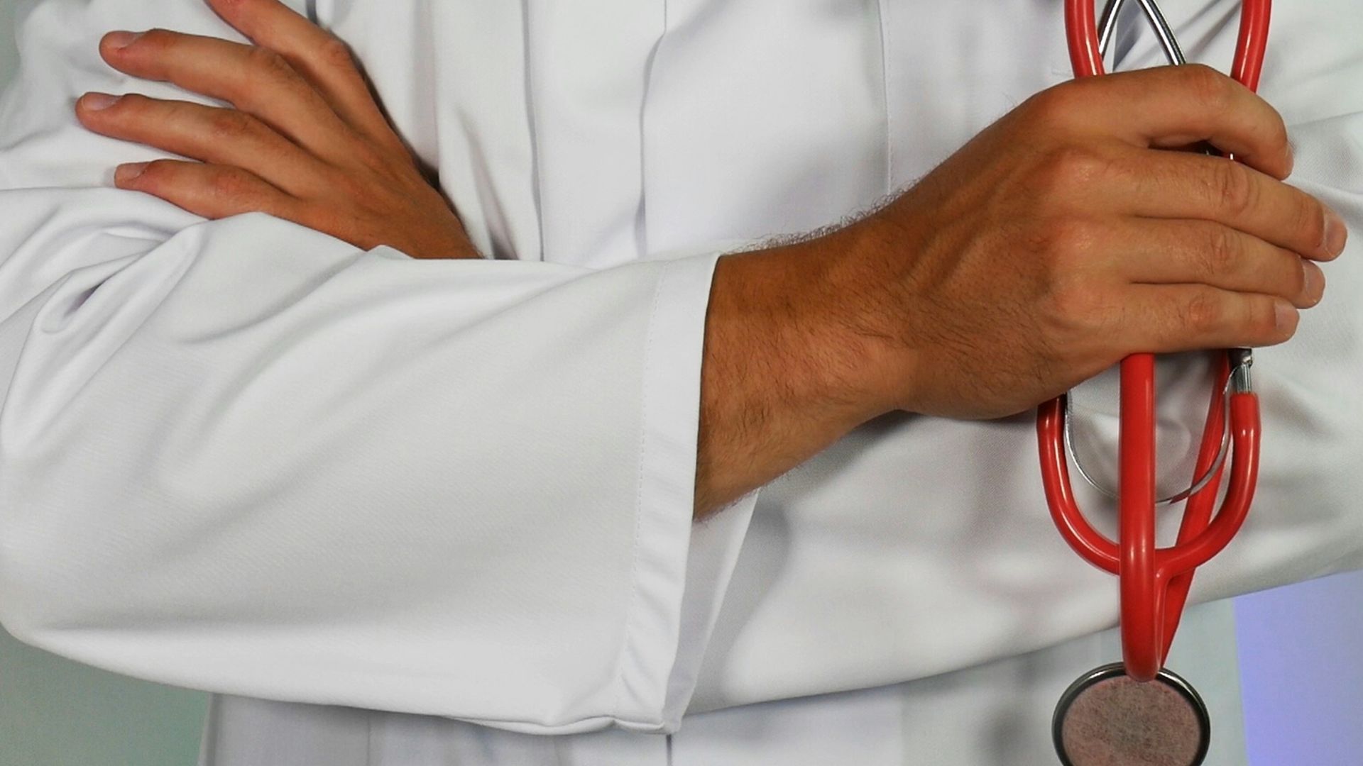 doctor holding red stethoscope