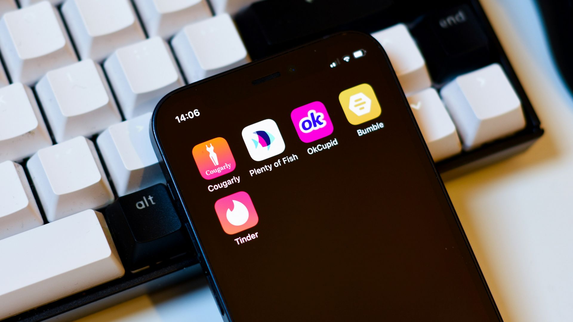 a cell phone sitting next to a keyboard