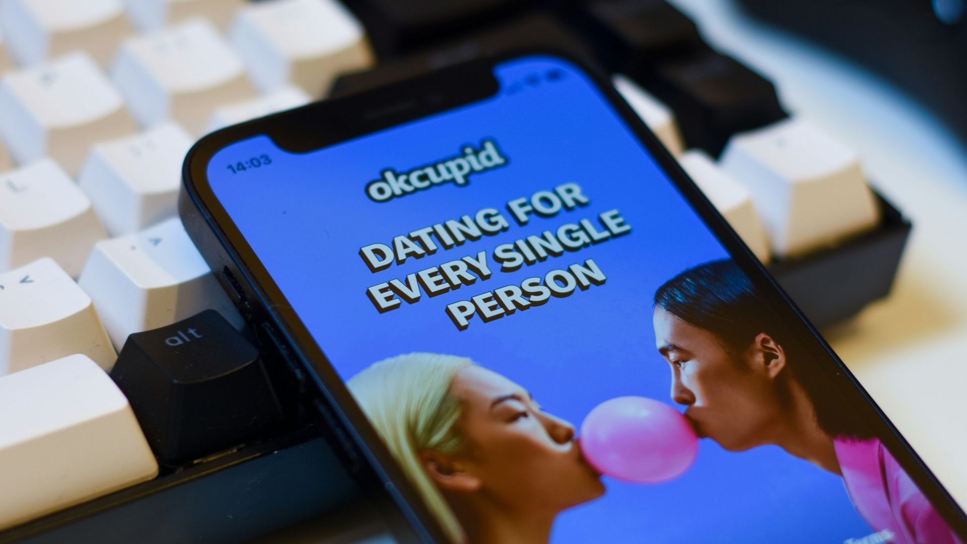 a cell phone sitting next to a keyboard