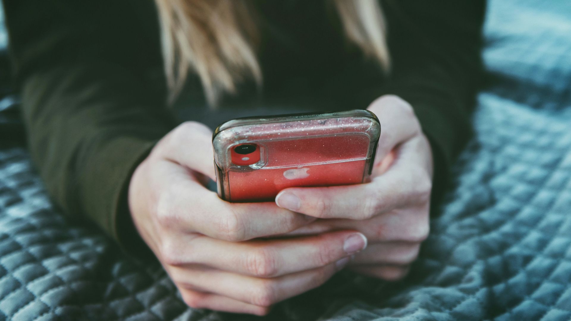 woman holding red and silver can
