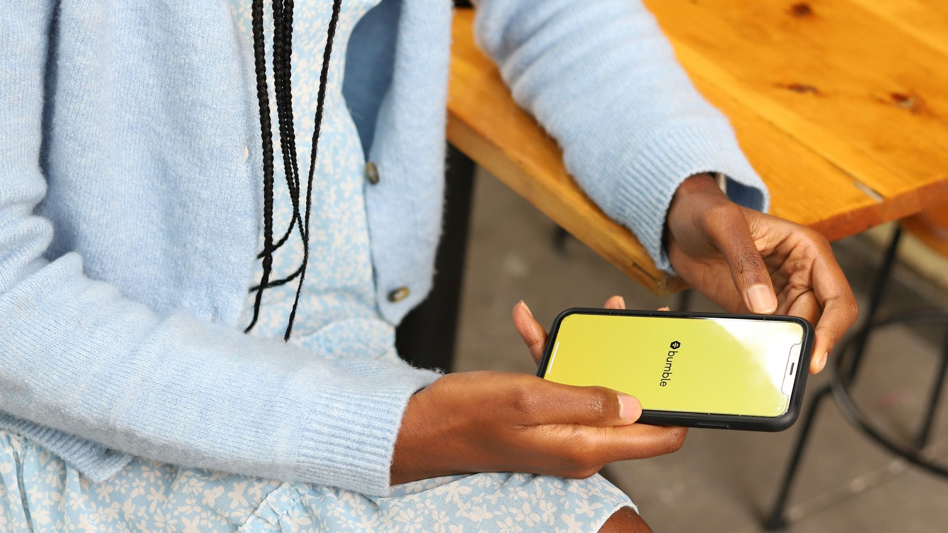 a woman sitting on a bench using a cell phone