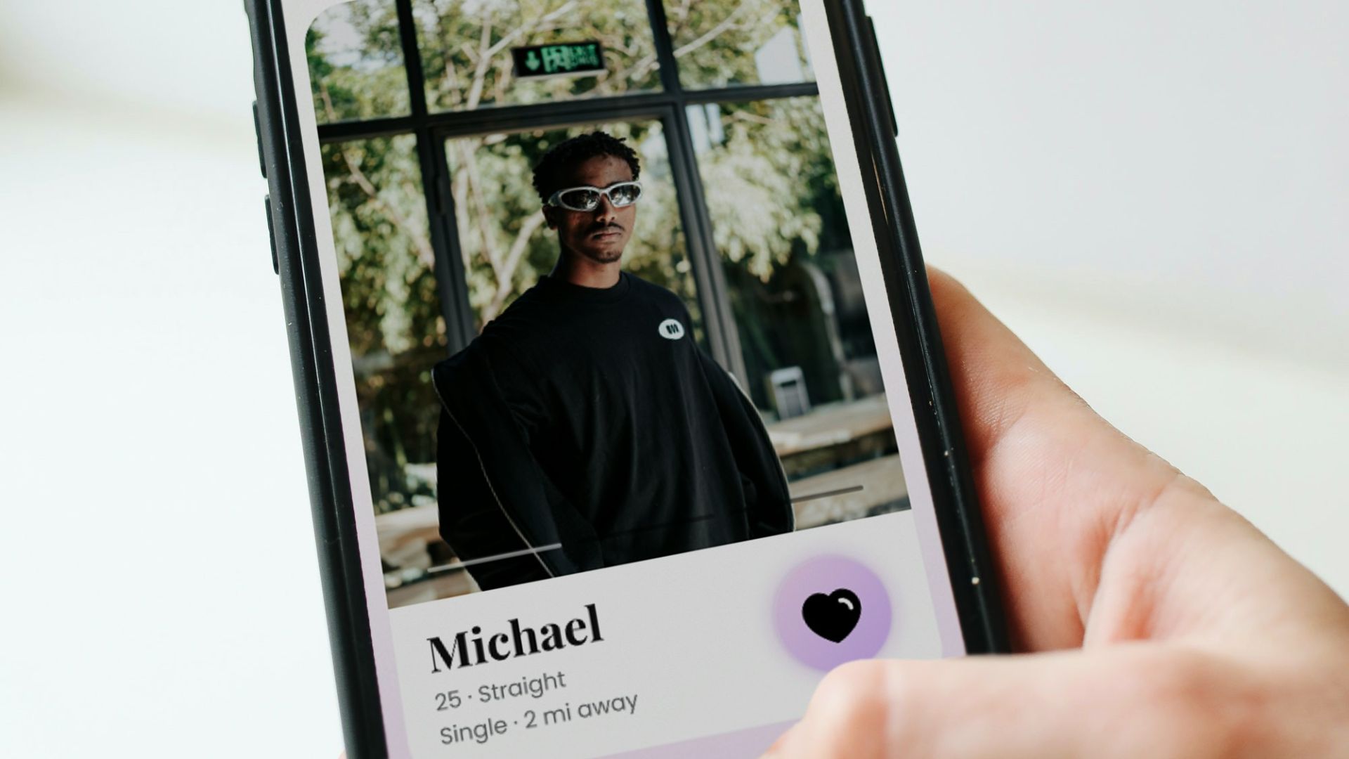 a person holding a cell phone with a picture of a man on it