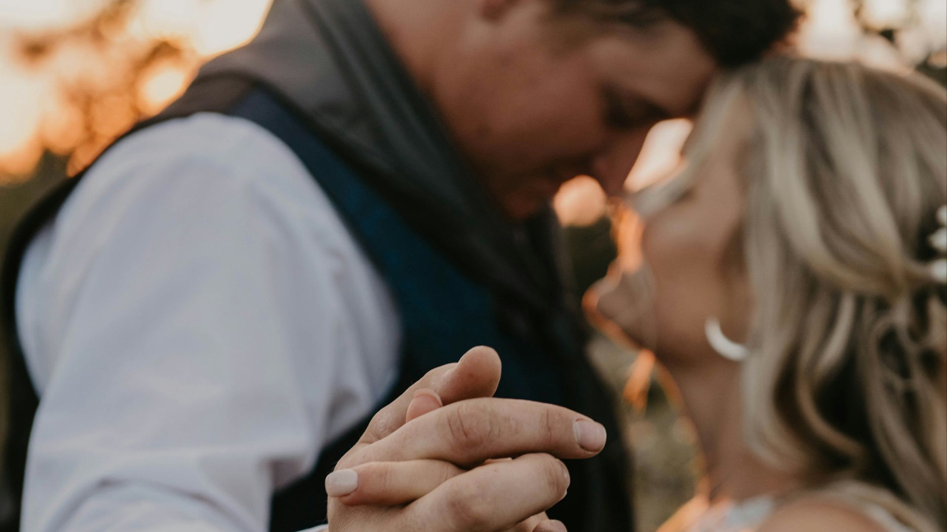 a bride and groom holding hands and smiling