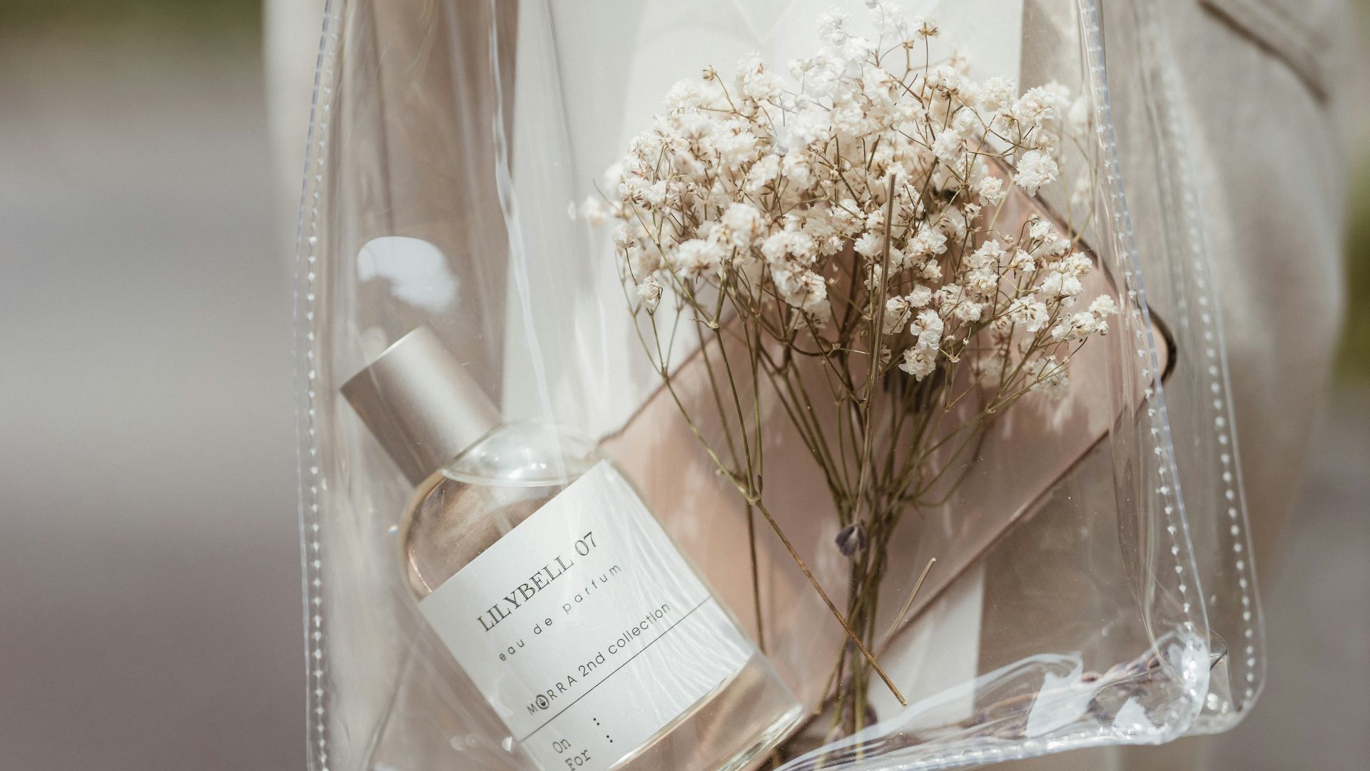 a person holding a clear bag with flowers in it