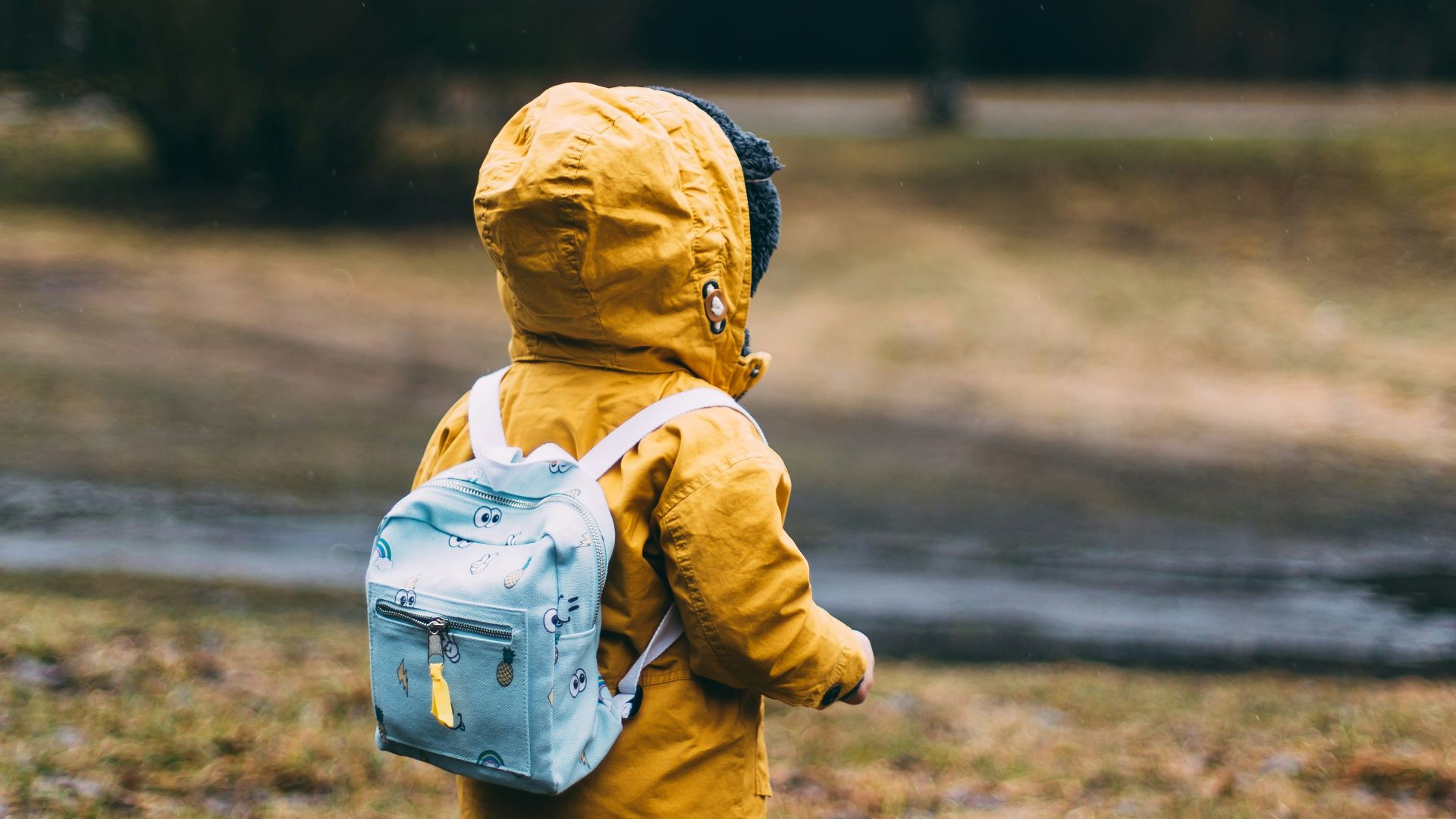 shallow focus photo of toddler walking near river