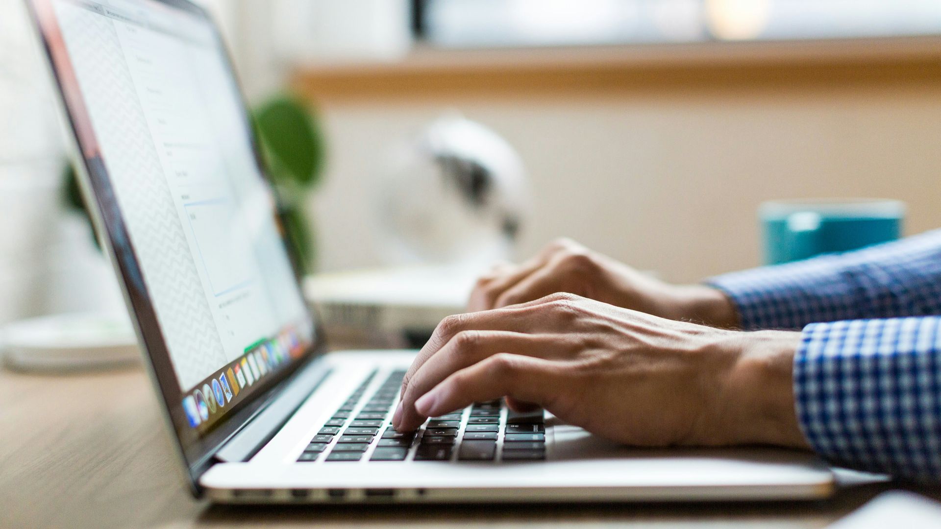 person typing on silver MacBook