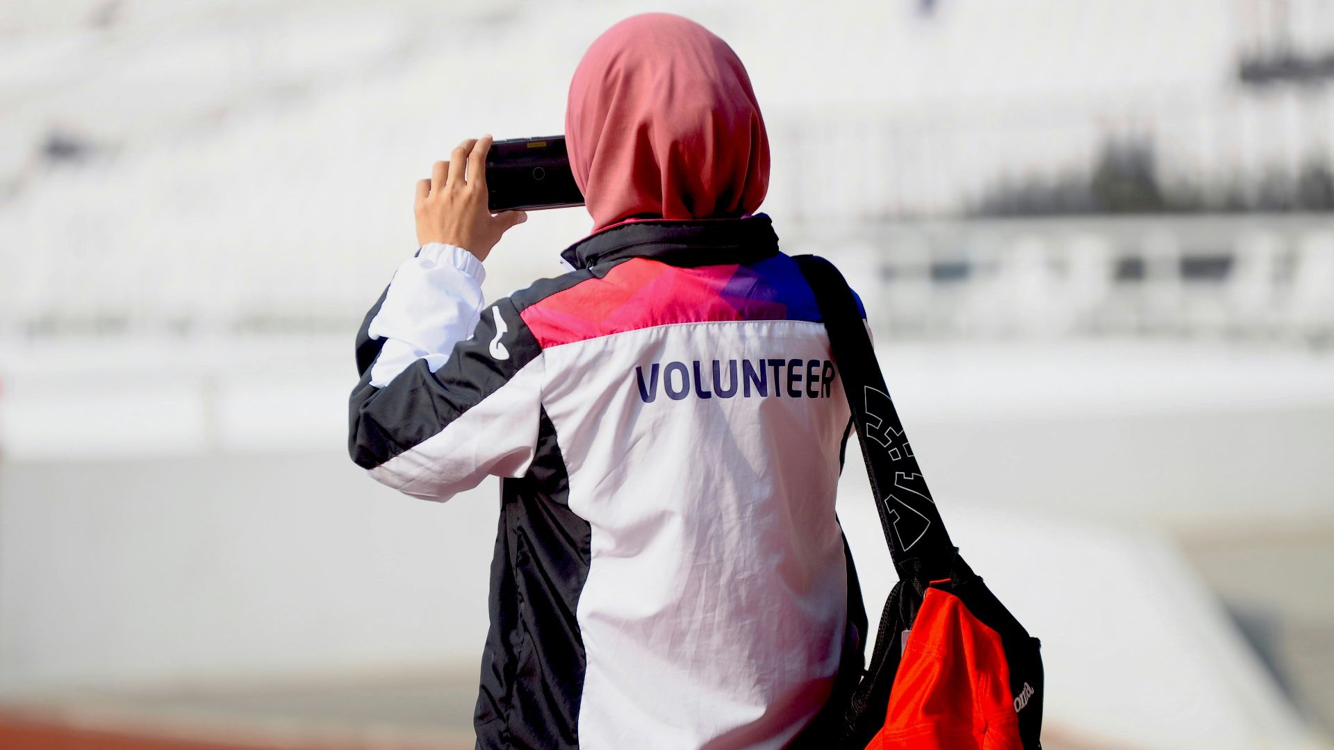 A woman taking a picture with her cell phone