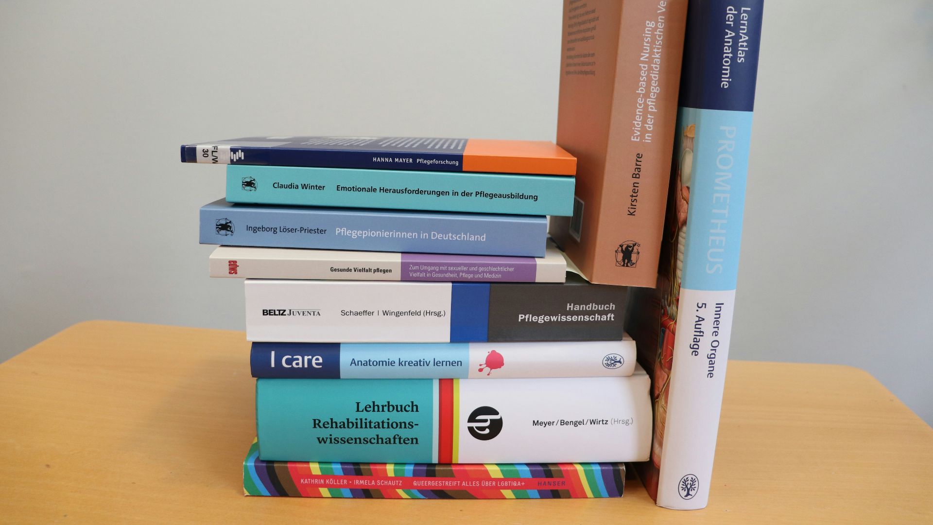 A stack of books sitting on top of a wooden table