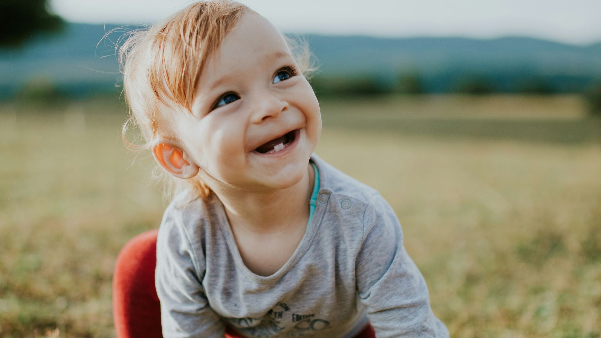 selective focus photo of baby crawling on grass