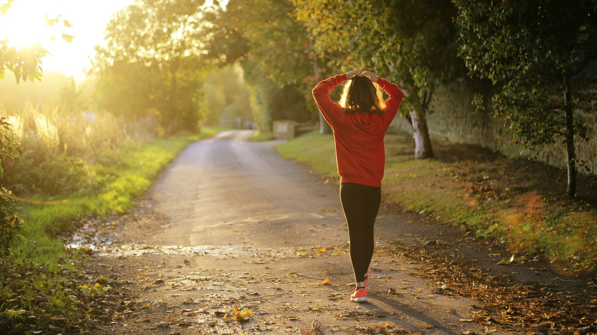 woman walking on pathway during daytime