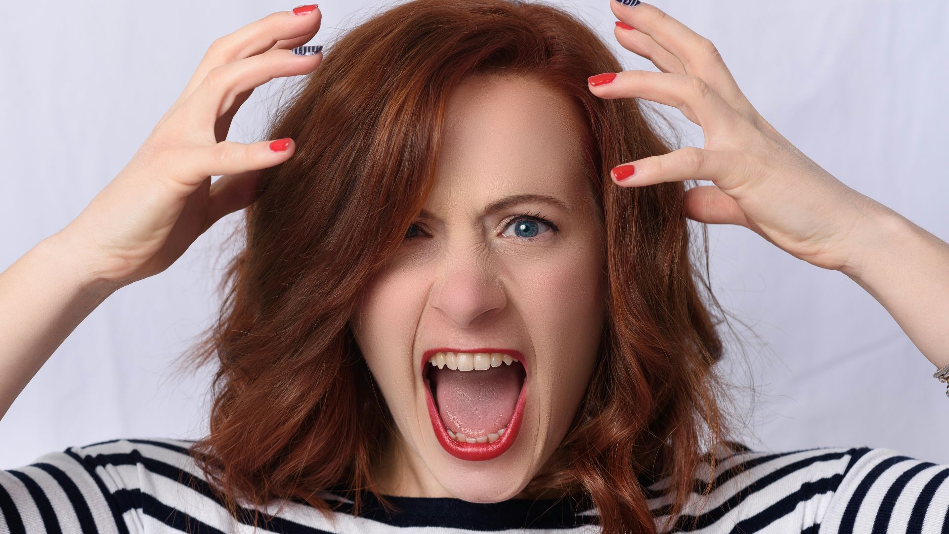 smiling girl in black and white striped shirt