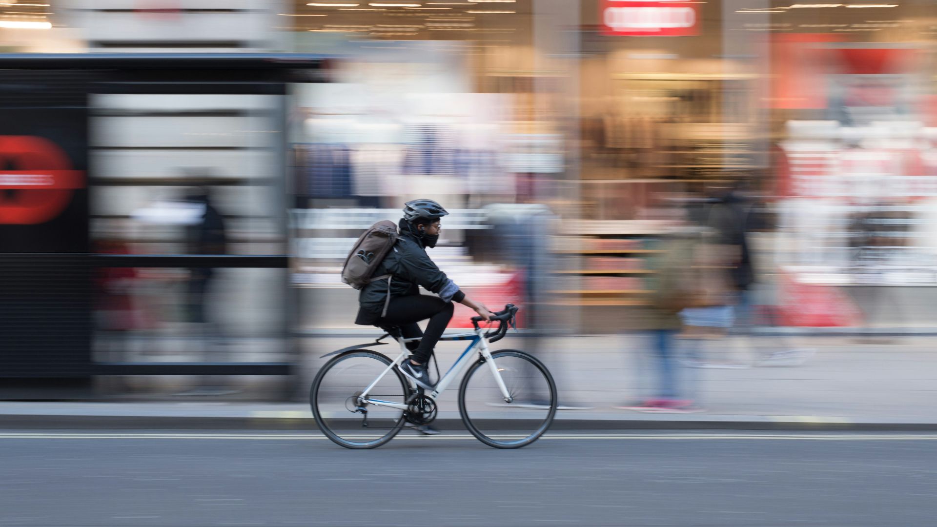 time lapse photo of person riding on white road bicycle