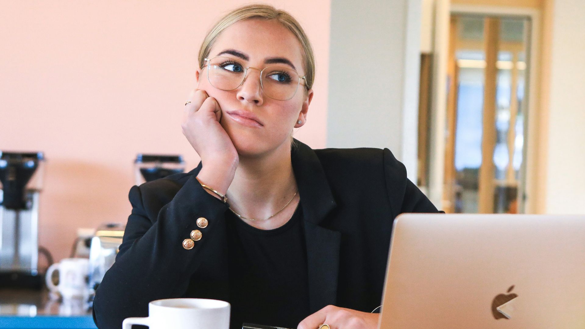 woman in black long sleeve shirt using macbook