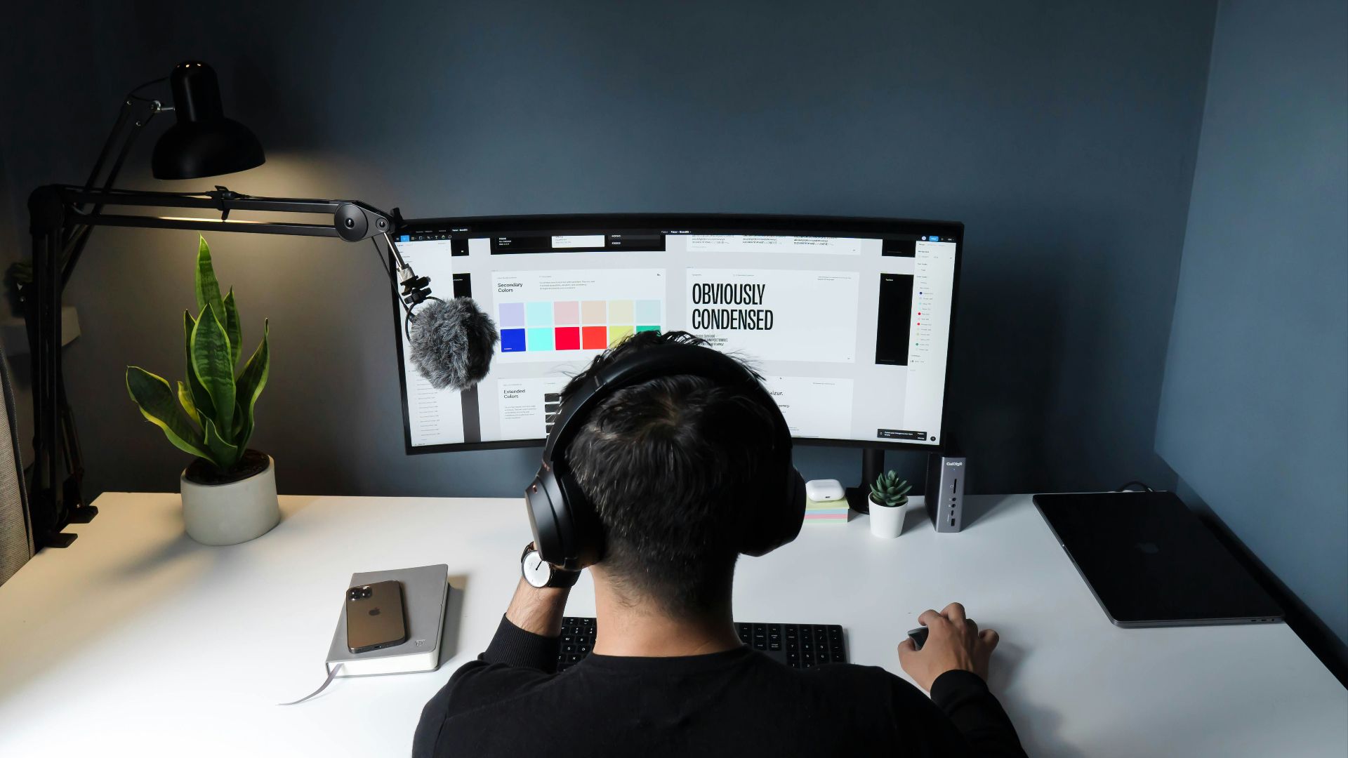 man in black shirt sitting in front of computer