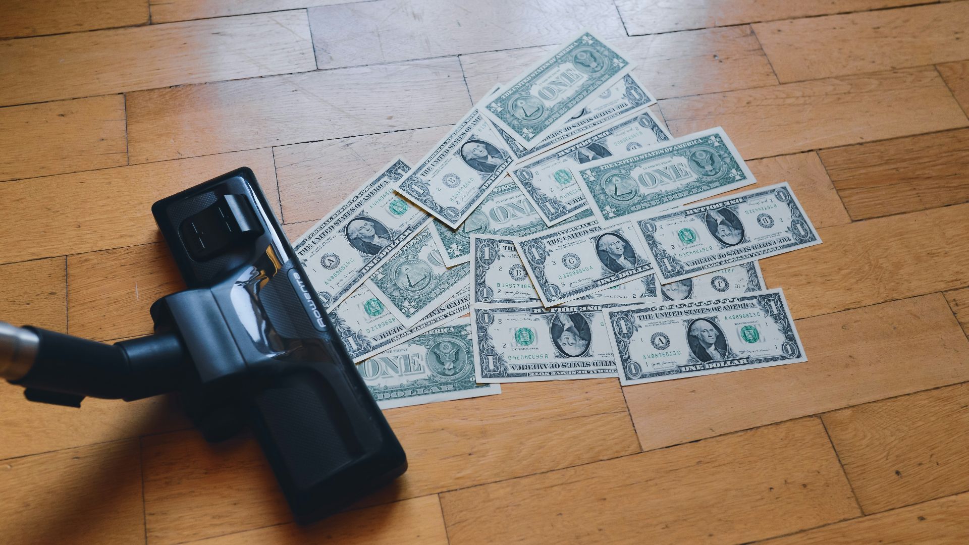 a pile of money sitting on top of a wooden floor