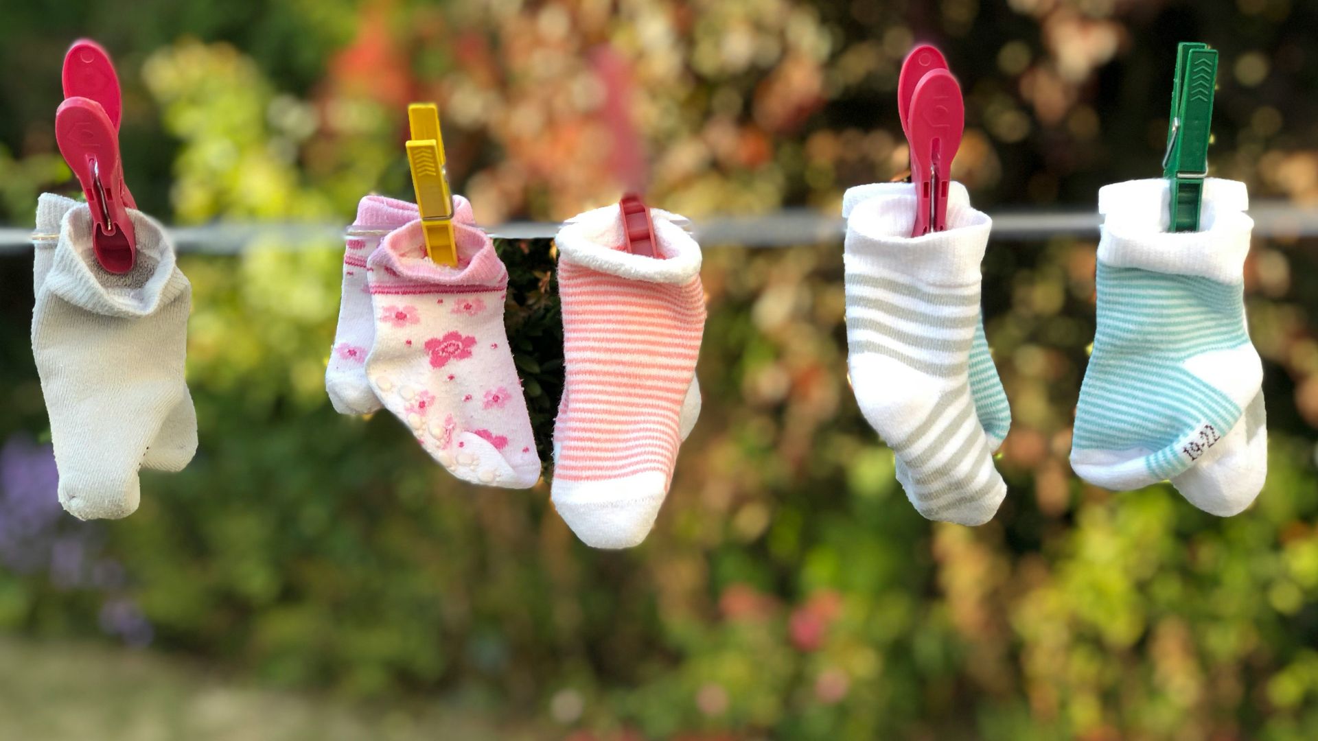 five pairs of socks pinned on clothesline