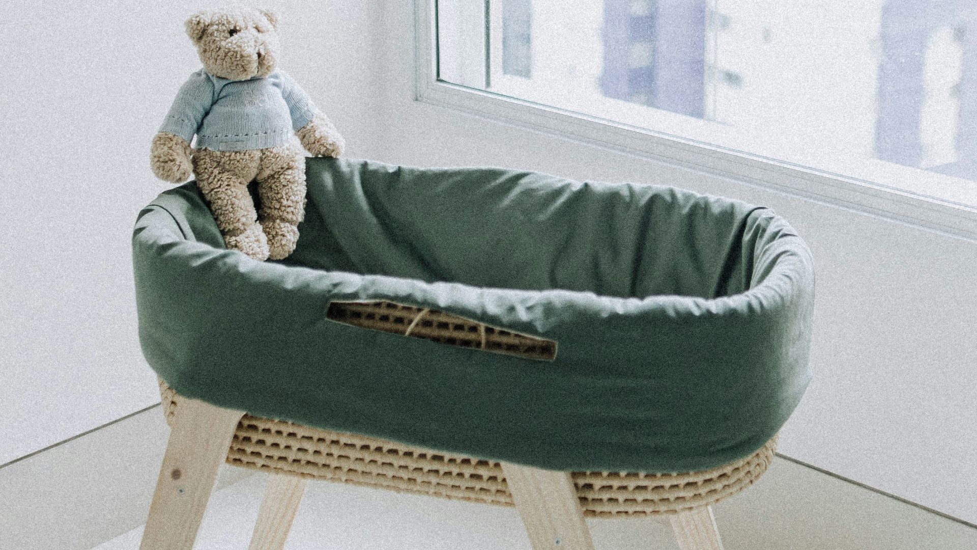 woman in green sweater lying on bed