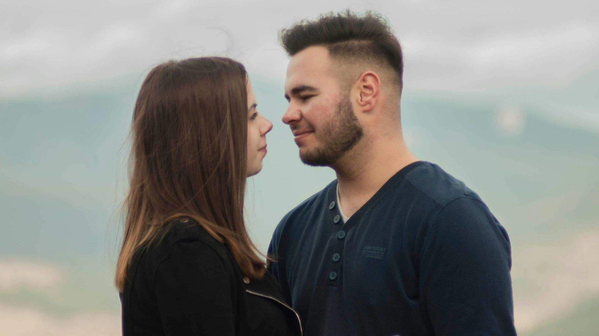 man in black long sleeve shirt kissing woman in black long sleeve shirt