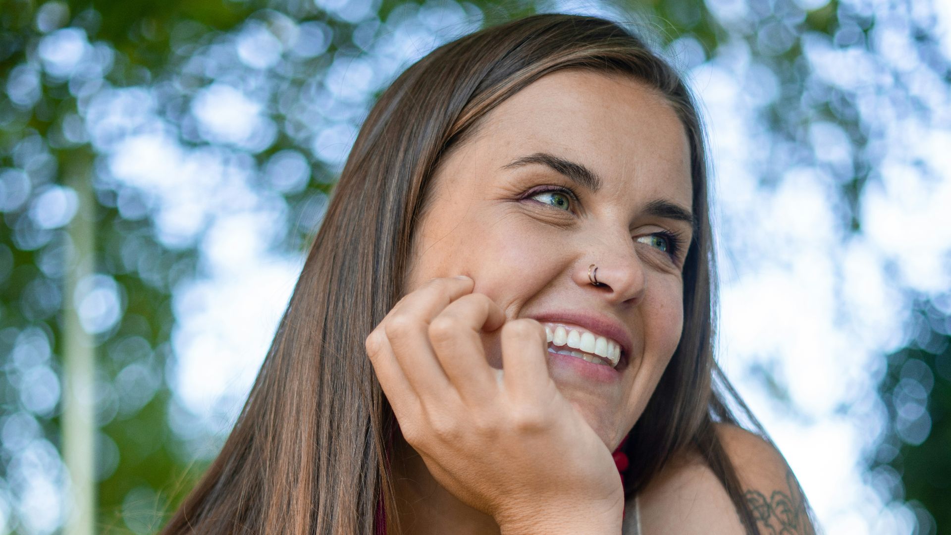 a woman sitting at a table with a smile on her face