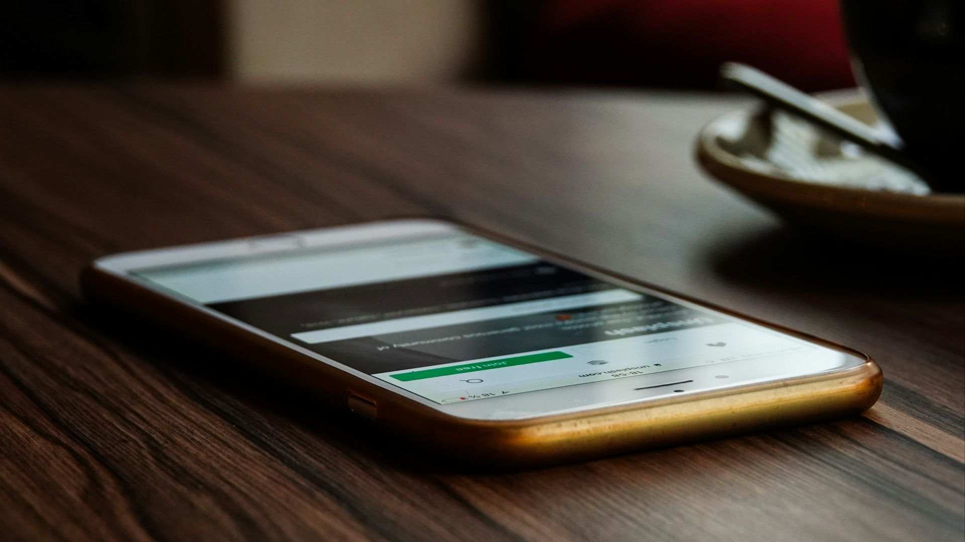 gold iPhone 6 on brown wooden surface