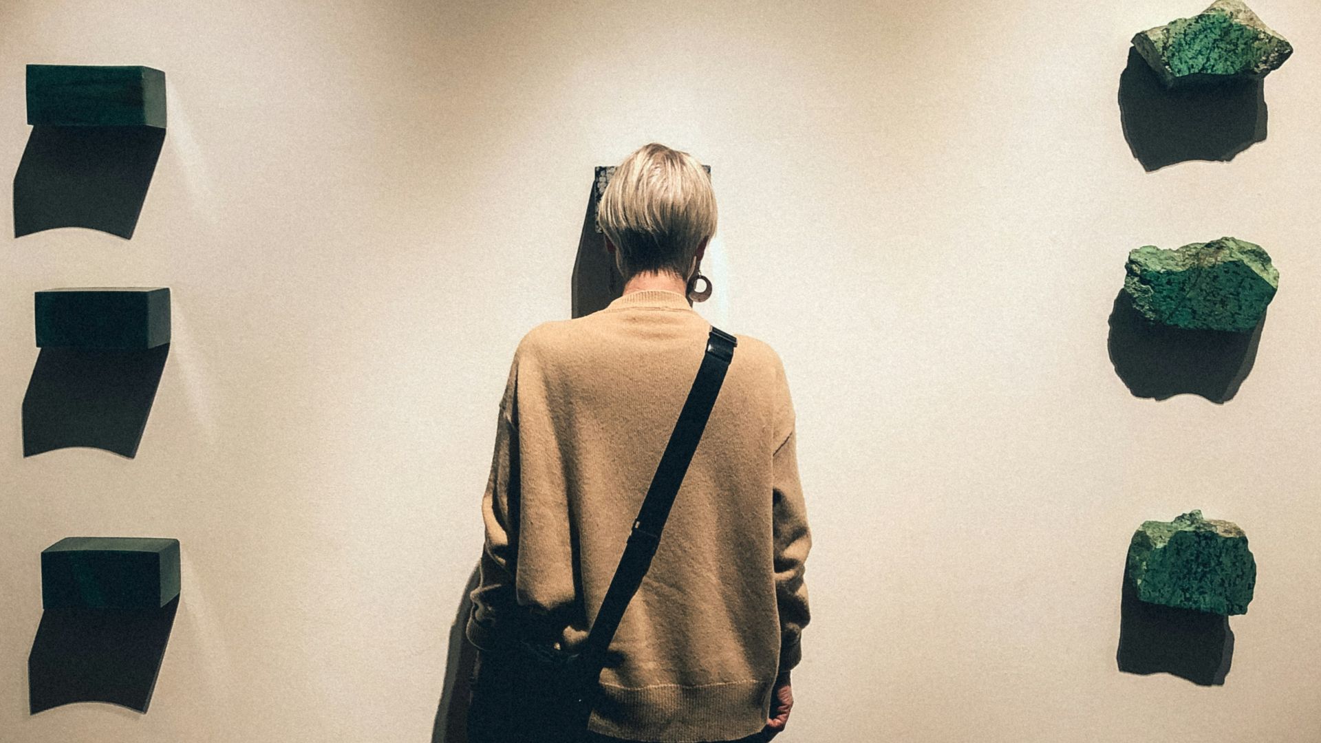 person standing in front of white wall