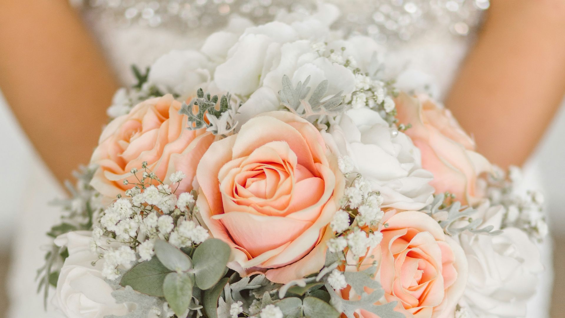 woman holding white and pink rose flower bouquet
