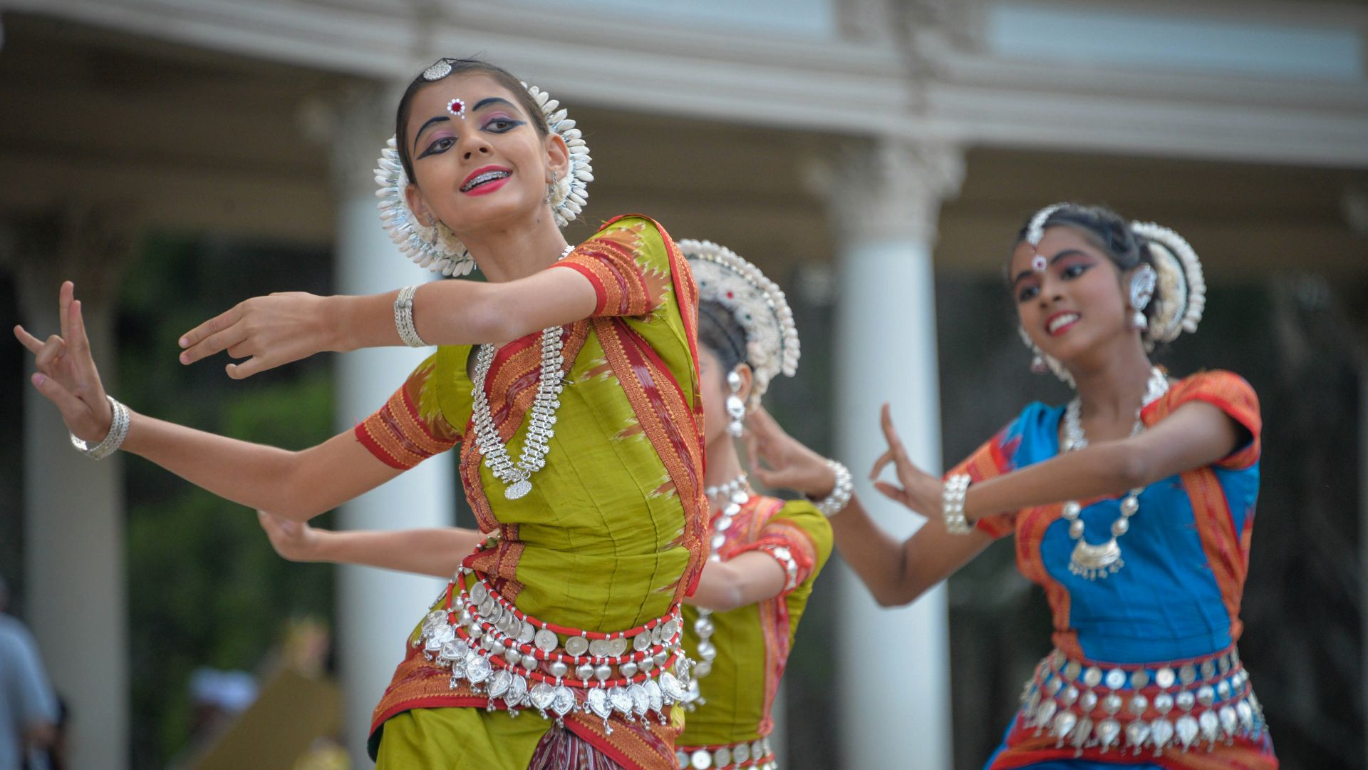 three woman performing traditional dance