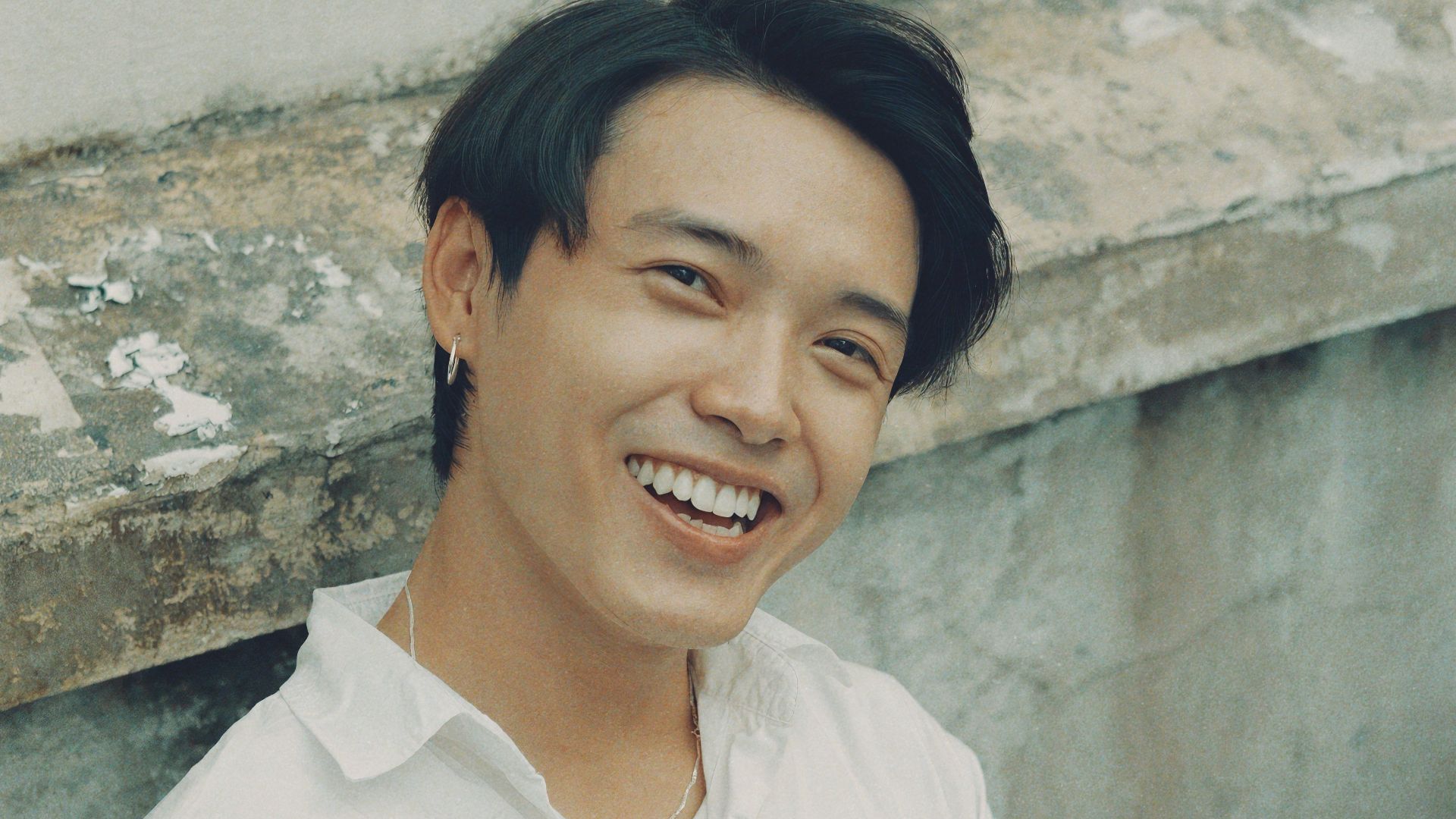 woman in white button up shirt smiling