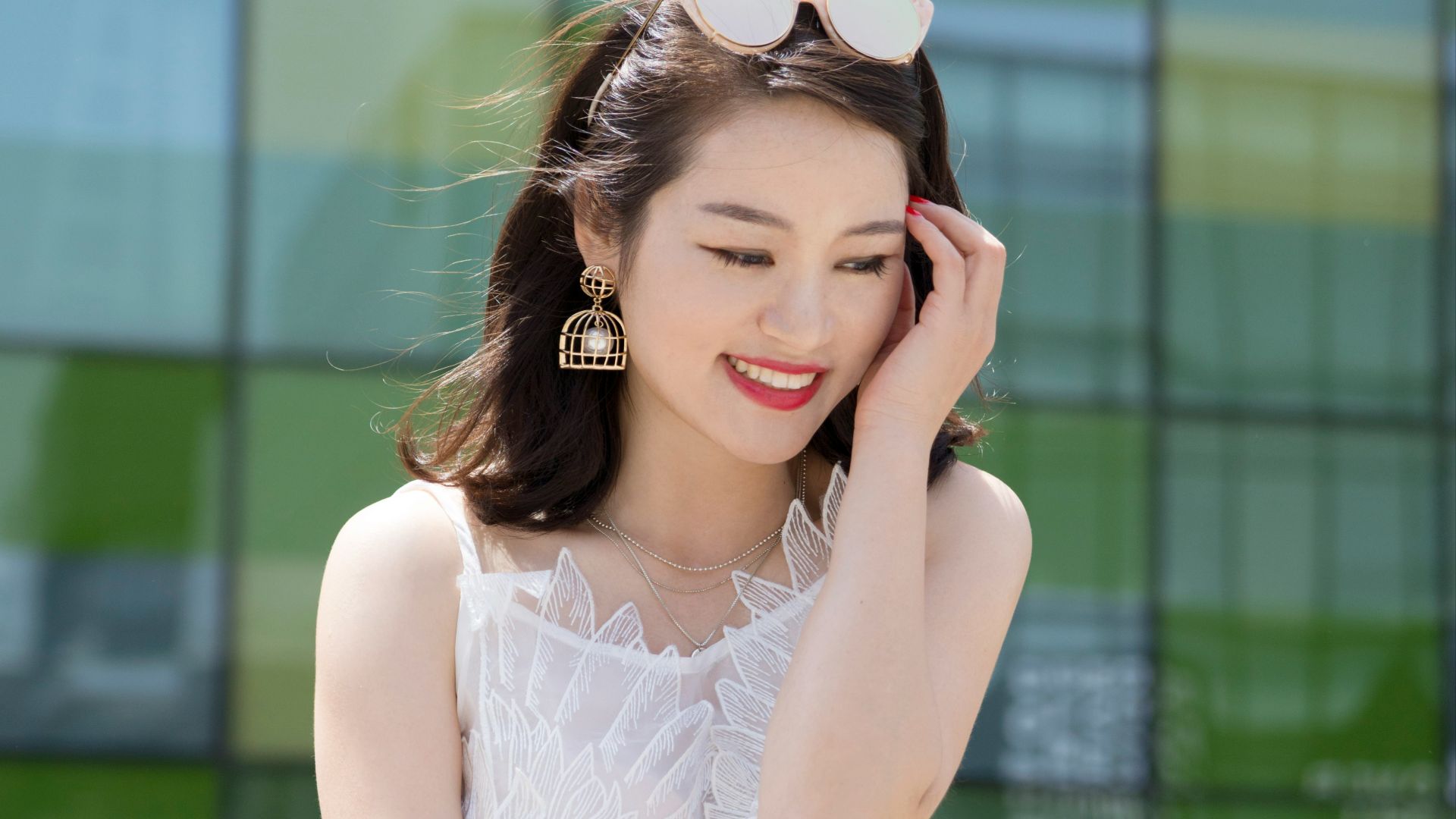 woman holding her head while sitting on table