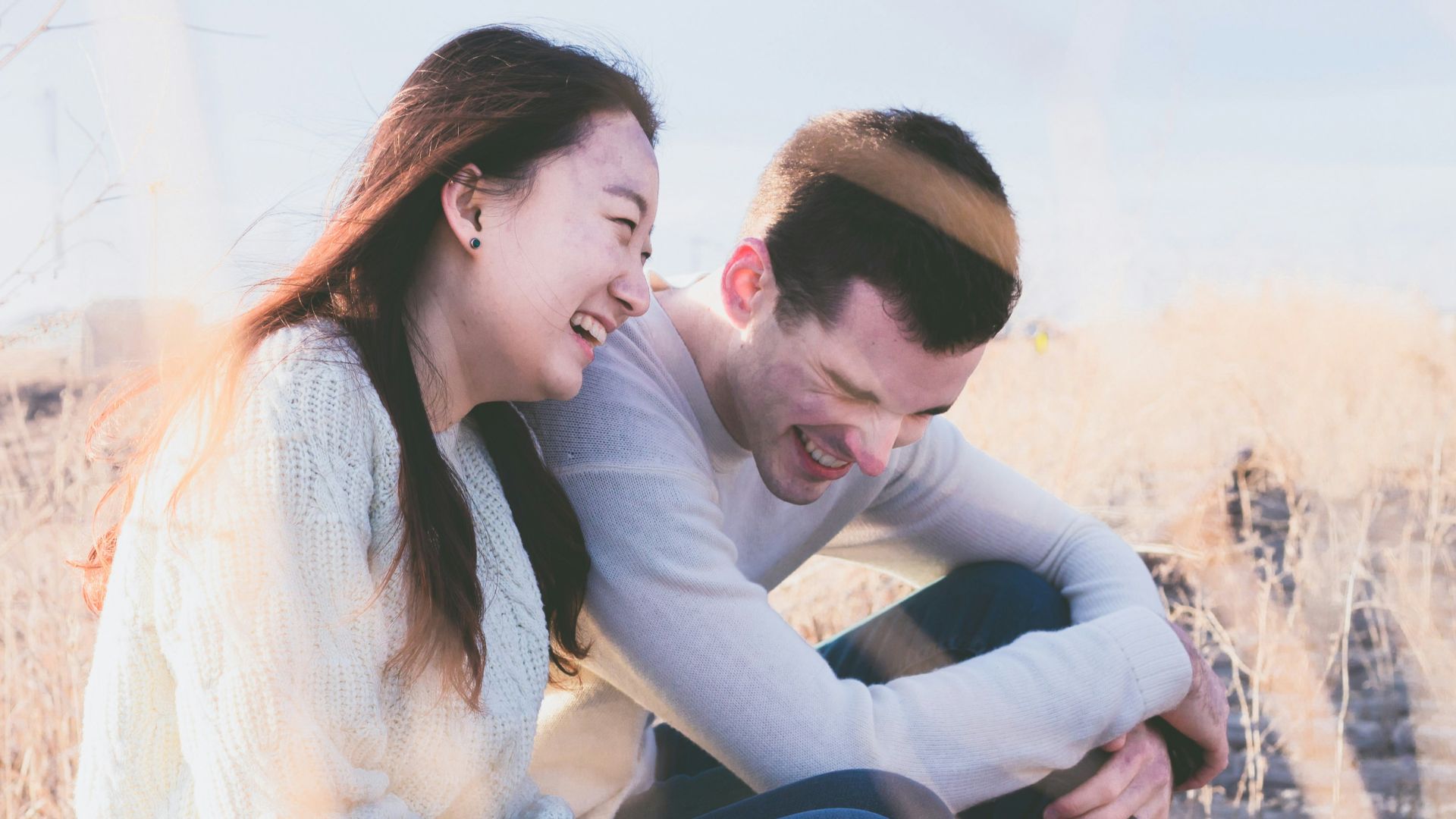 photo of man and woman laughing during daytime