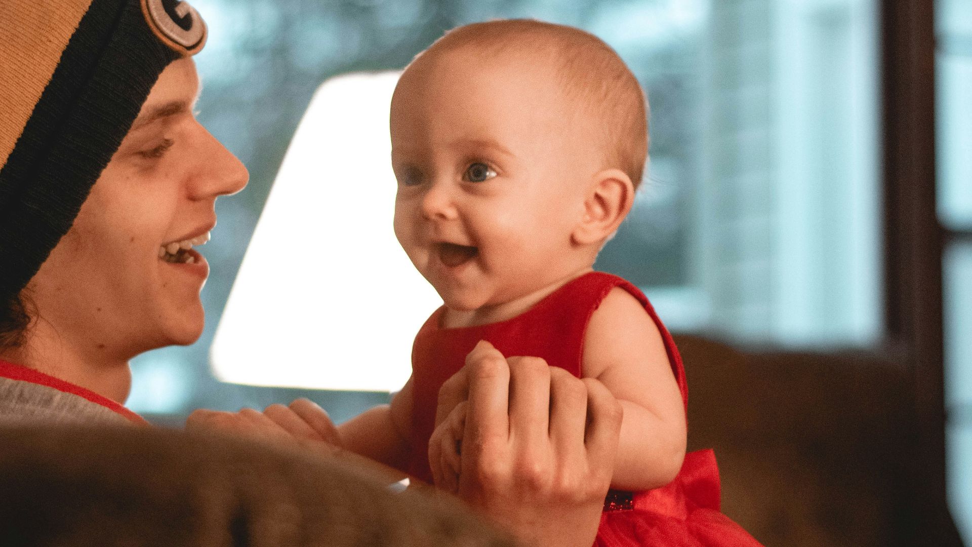 smiling woman holding a smiling child