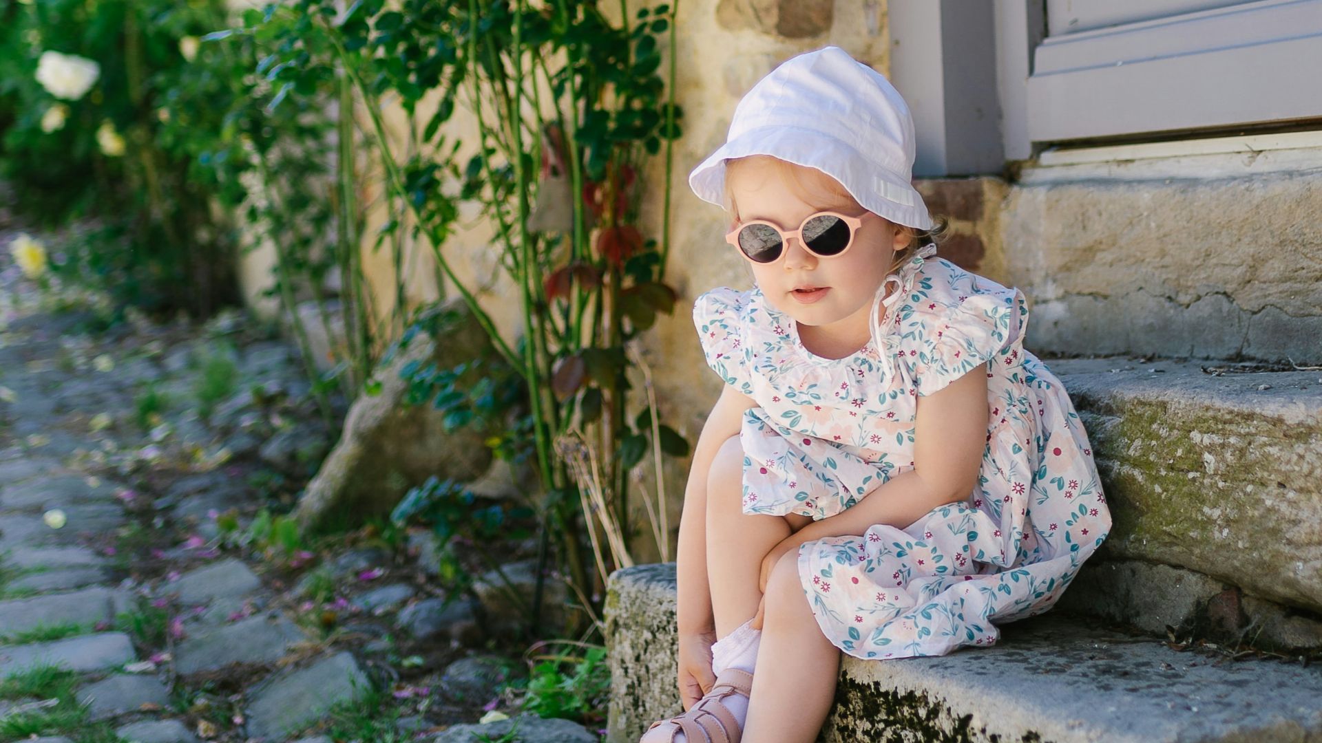 a little girl that is sitting on some steps