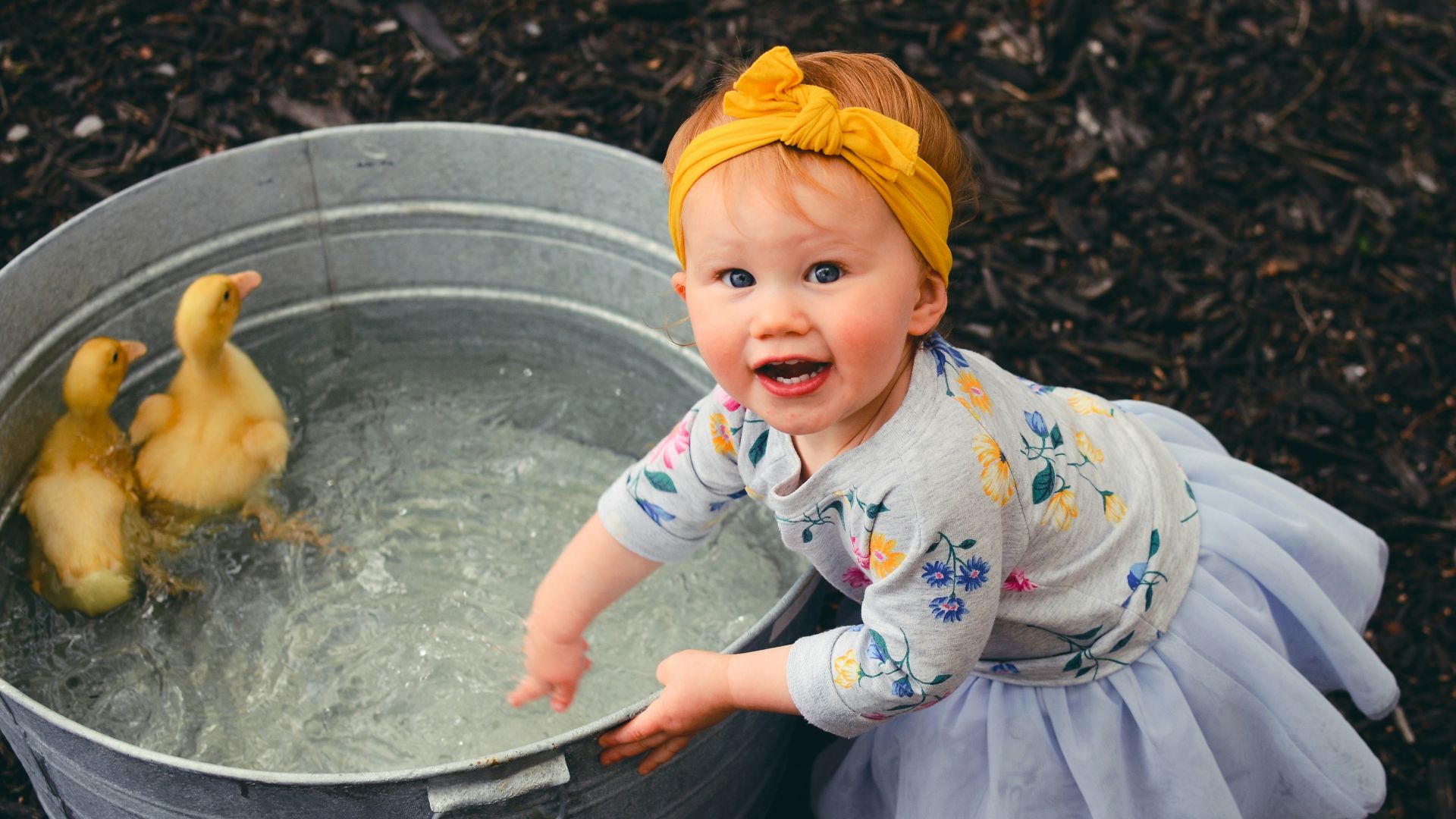 shallow focus photo of girl playing water