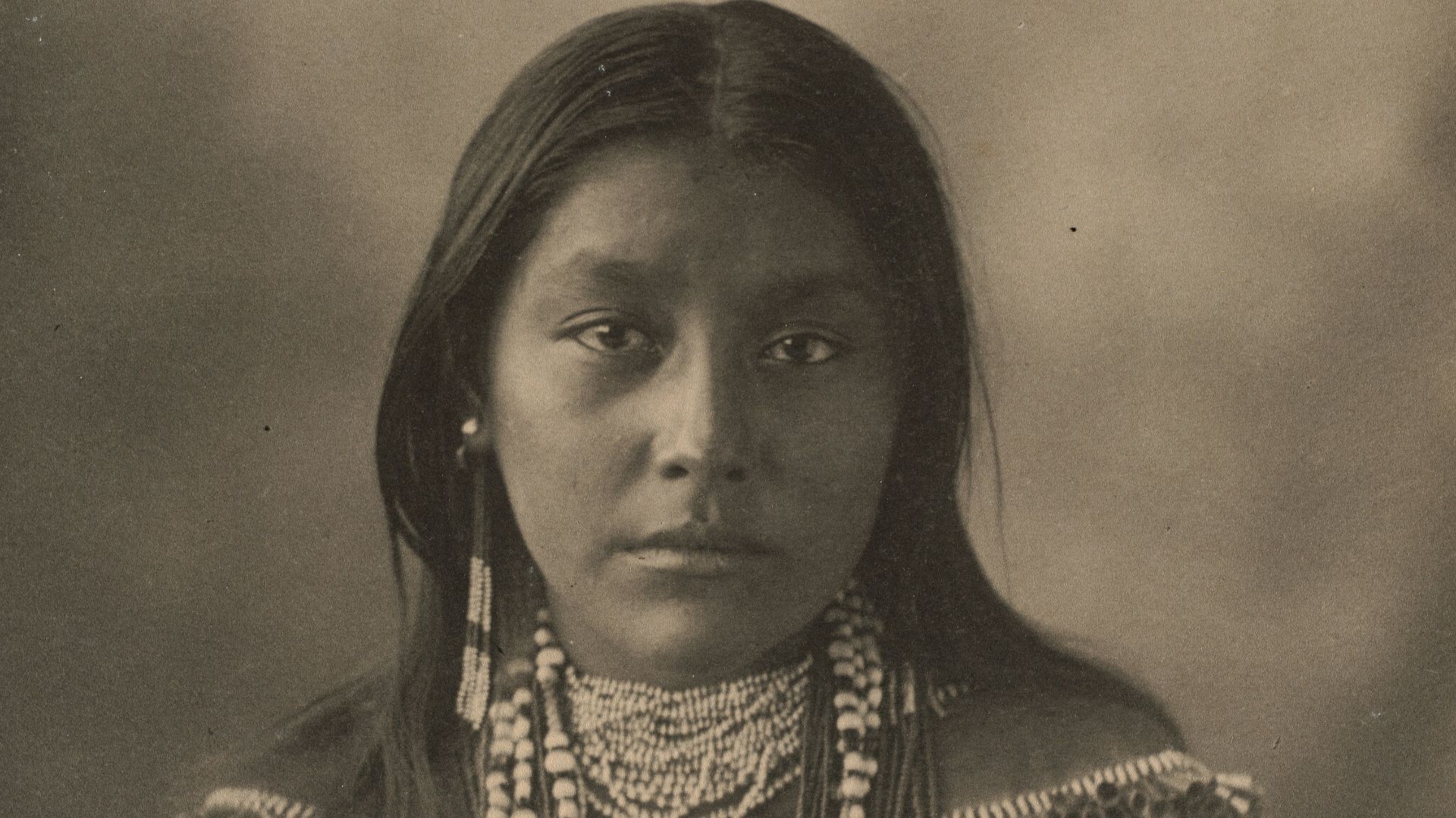 woman in black and gold dress