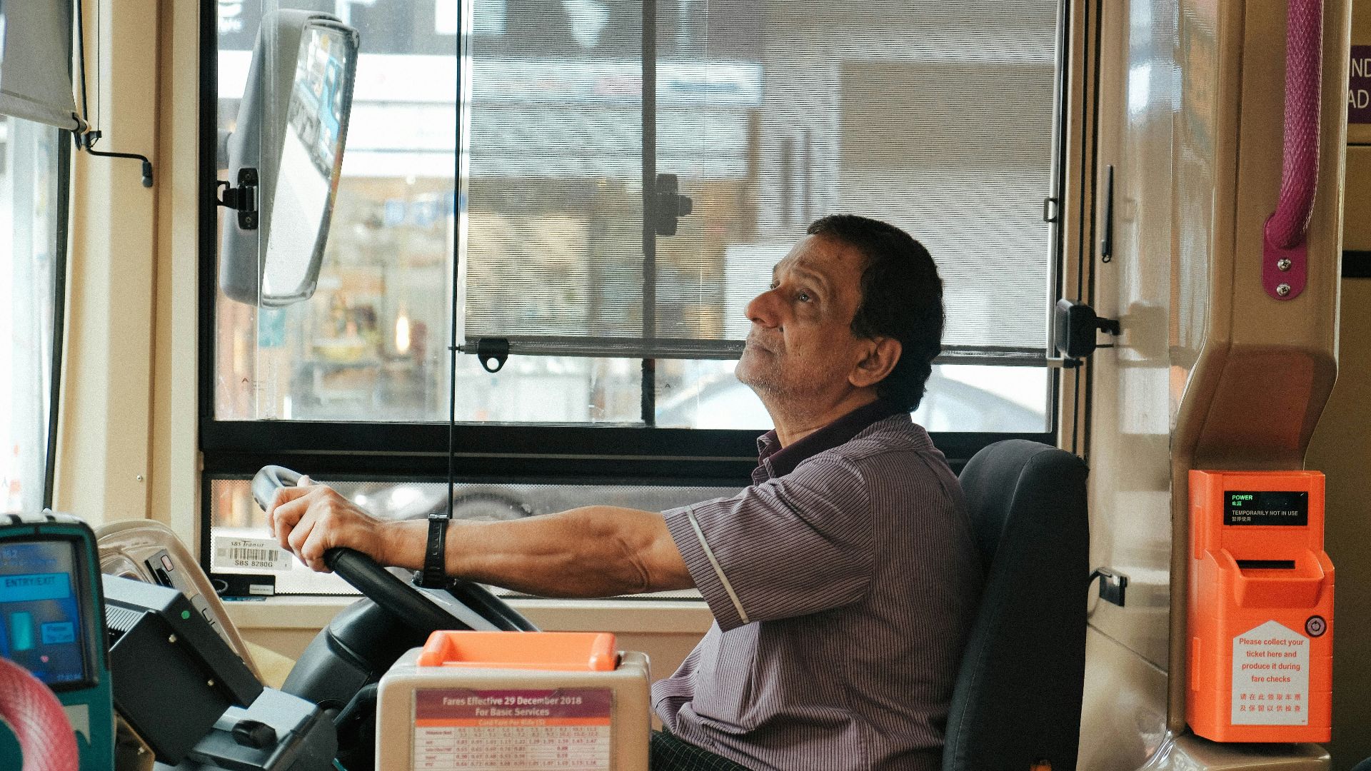 man in brown and white plaid button up shirt sitting on black office rolling chair