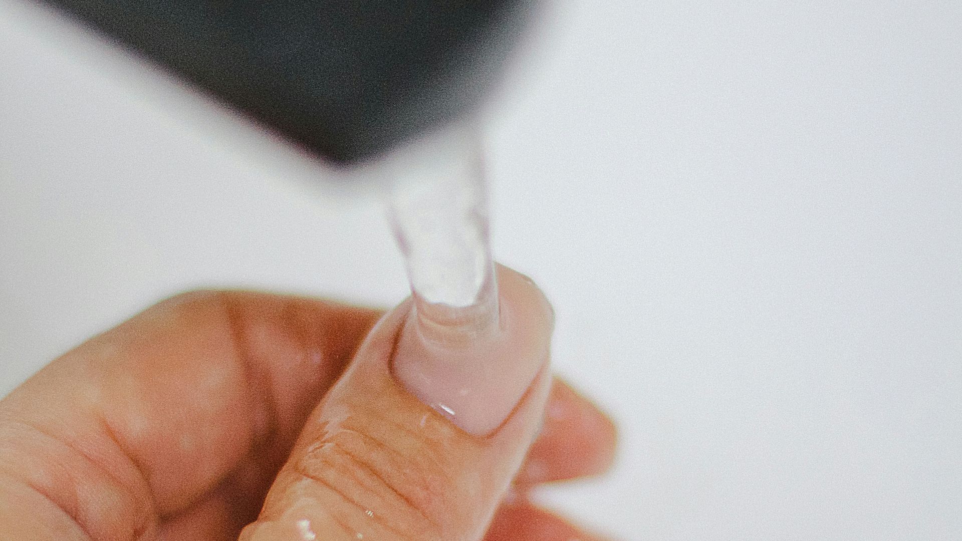 a hand holding a small light bulb