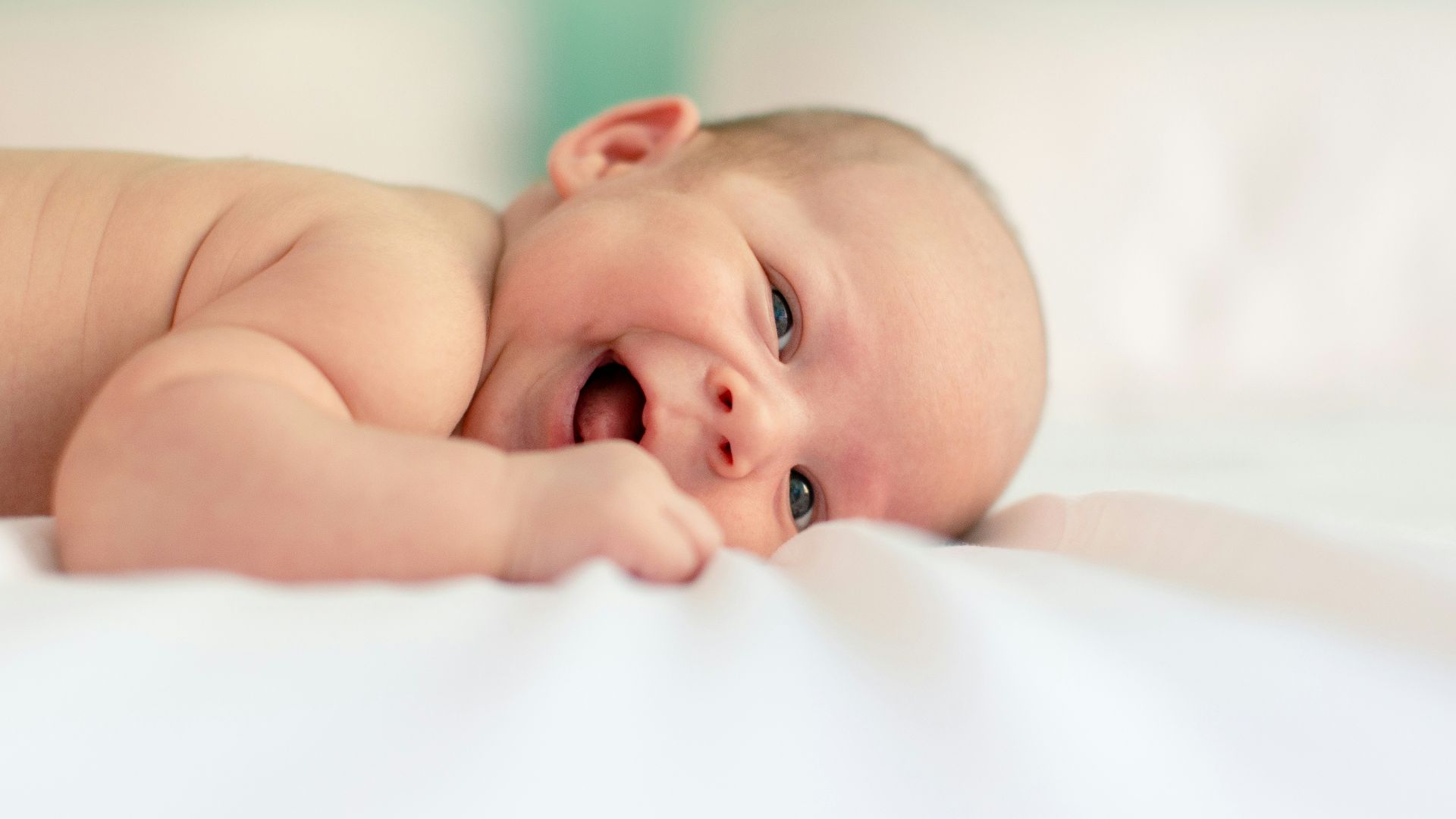 baby lying on fabric cloth