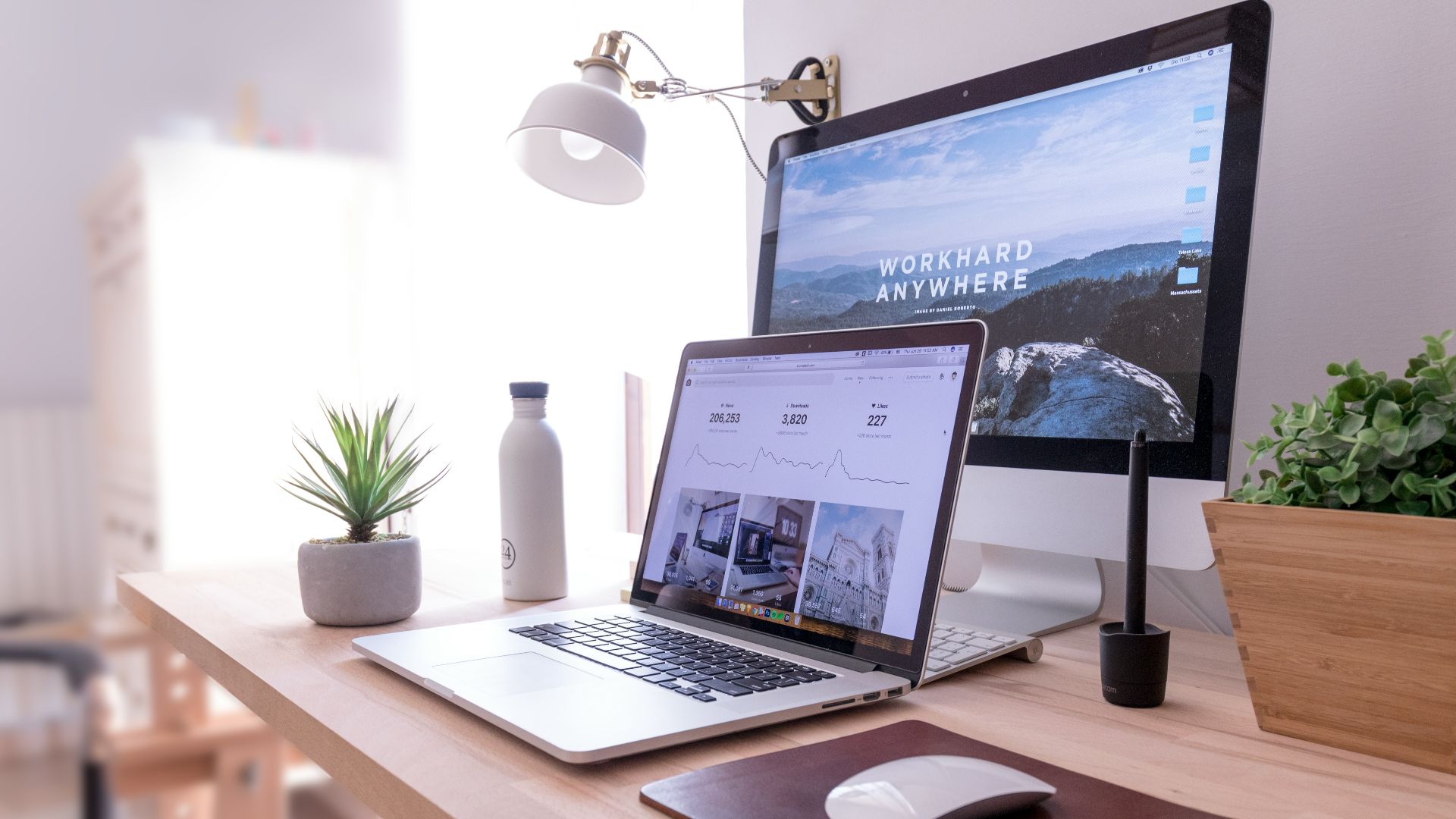 MacBook Pro on table beside white iMac and Magic Mouse