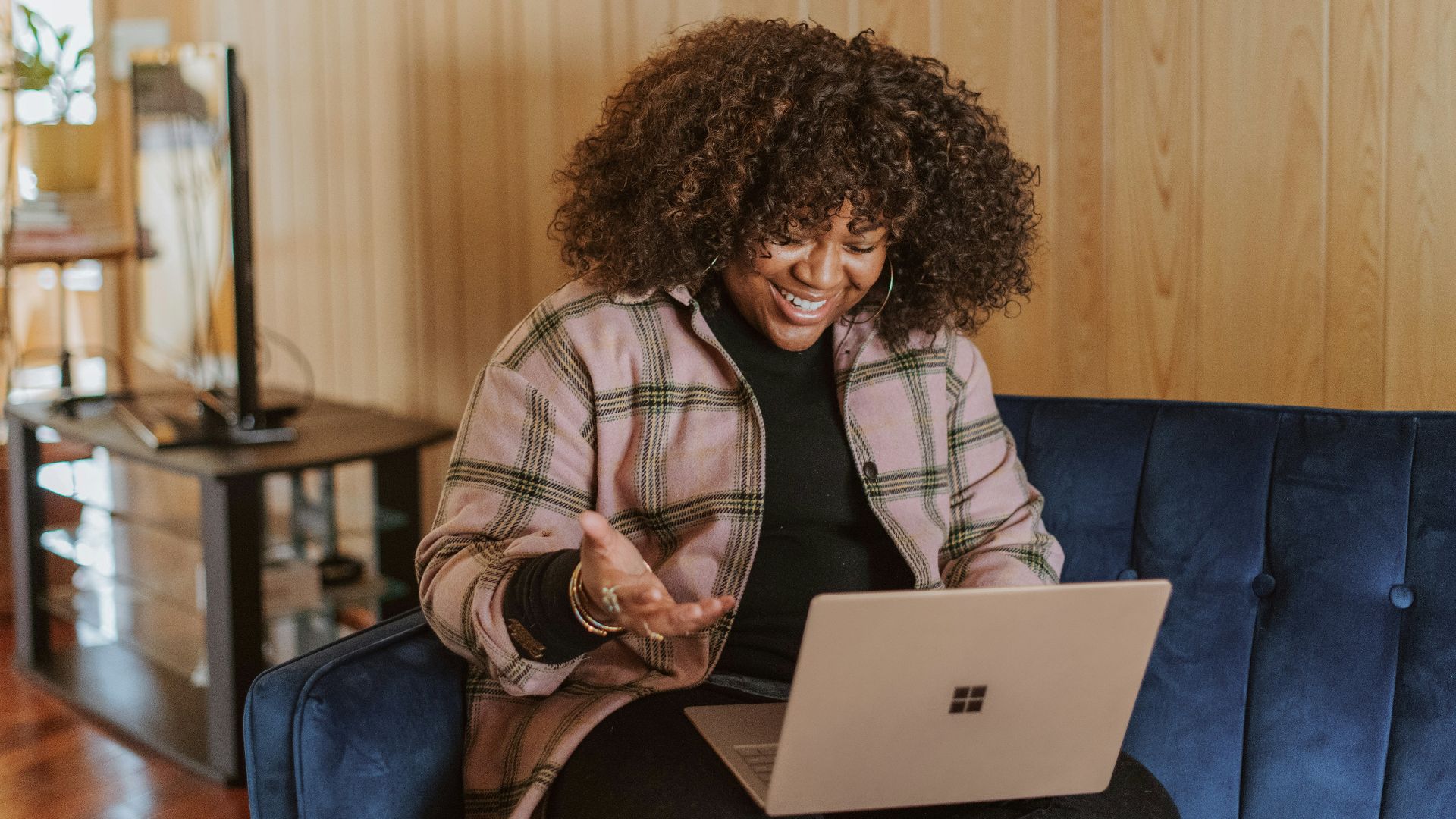 person sitting on couch holding a Surface device