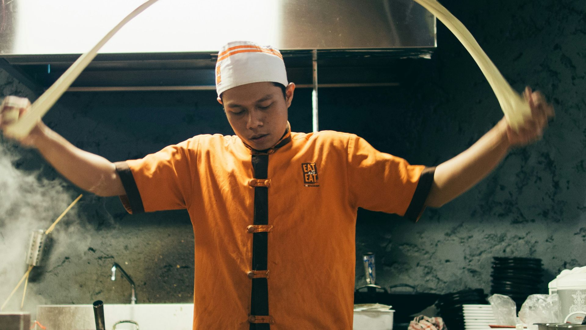 chef making pasta inside kitchen