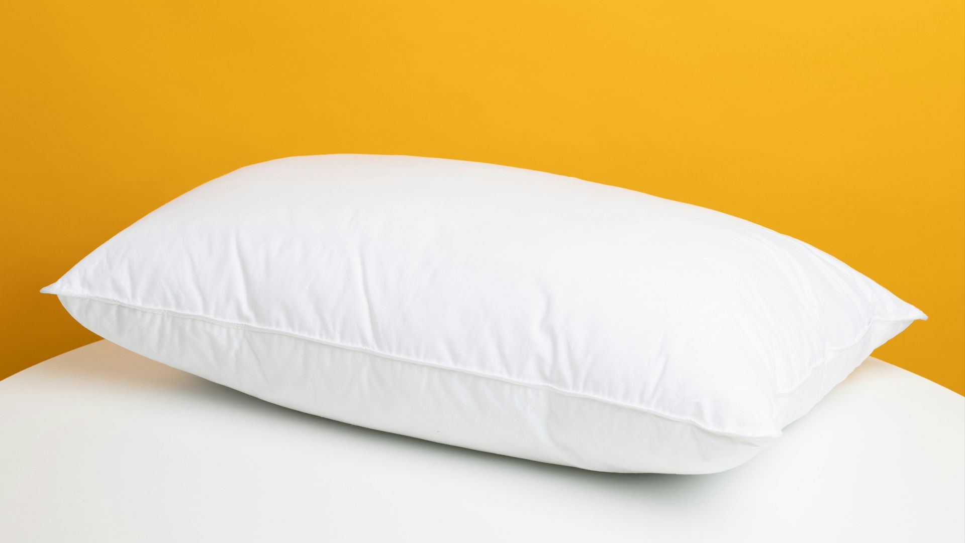white pillow on white bed