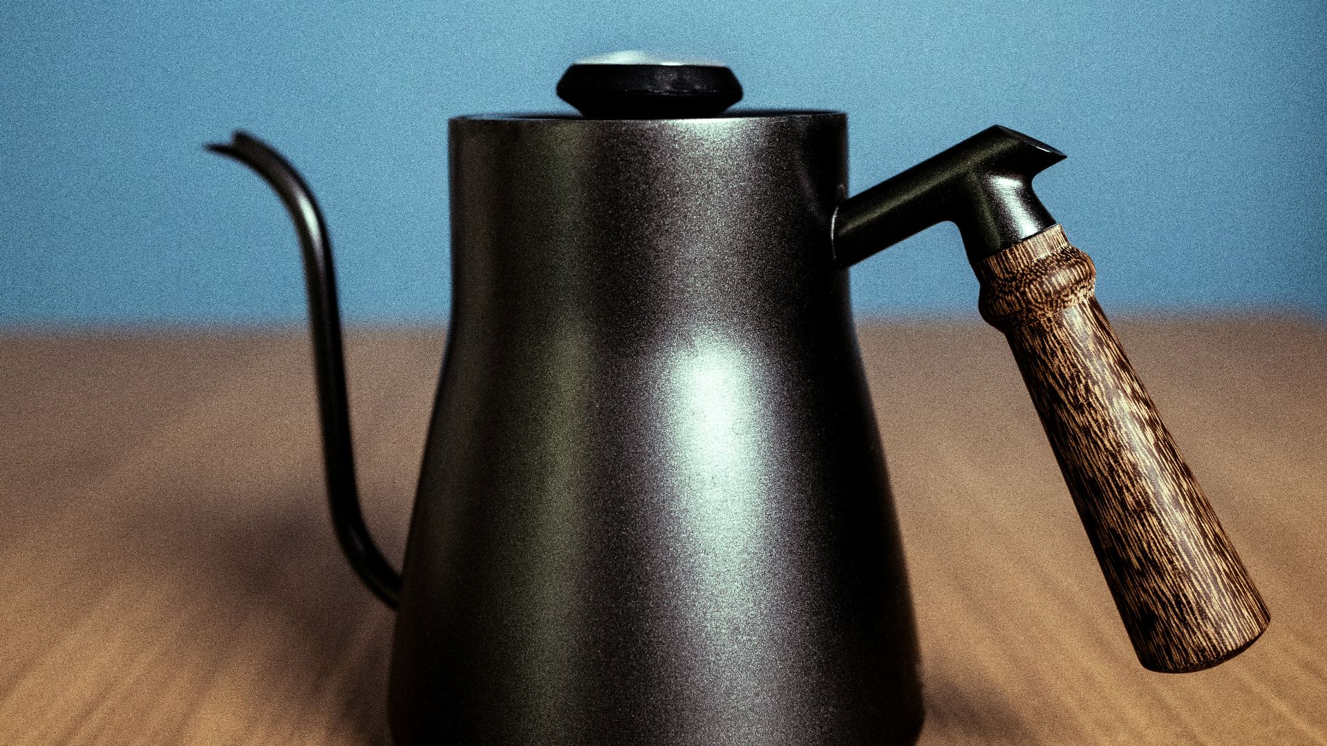 black kettle on brown wooden table